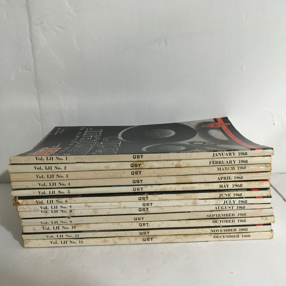 Stacked complete set of 12 QST Amateur Radio magazines from 1968, each labeled with their respective month, representing Vol. 52.