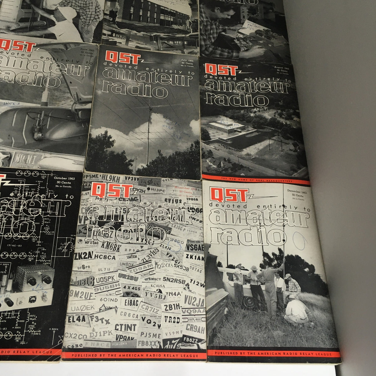 Lot of 12 Complete January to December 1963 QST Amateur Radio Volume 1-12 showing the stacked magazines that document amateur radio history with intriguing visuals.