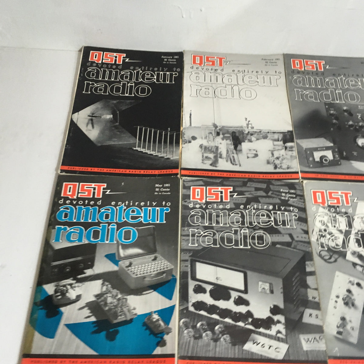 Lot of 12 Complete January to December 1961 QST Amateur Radio magazines featuring vintage cover designs from different months, highlighting early amateur radio technology.