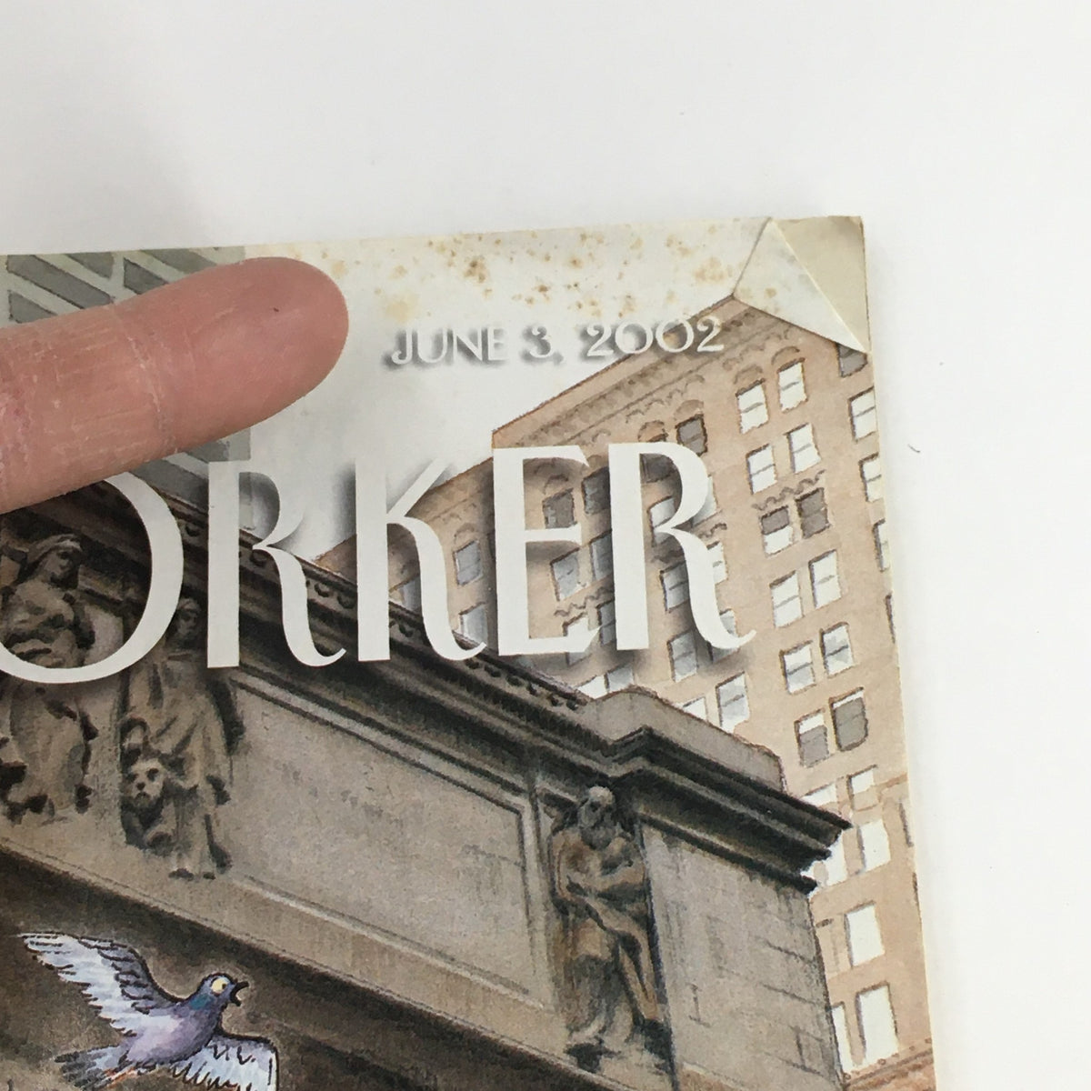 Detailed view of the June 3 2002 issue of The New Yorker magazine, highlighting the corner with a date stamp and slight wear, including a folded corner.