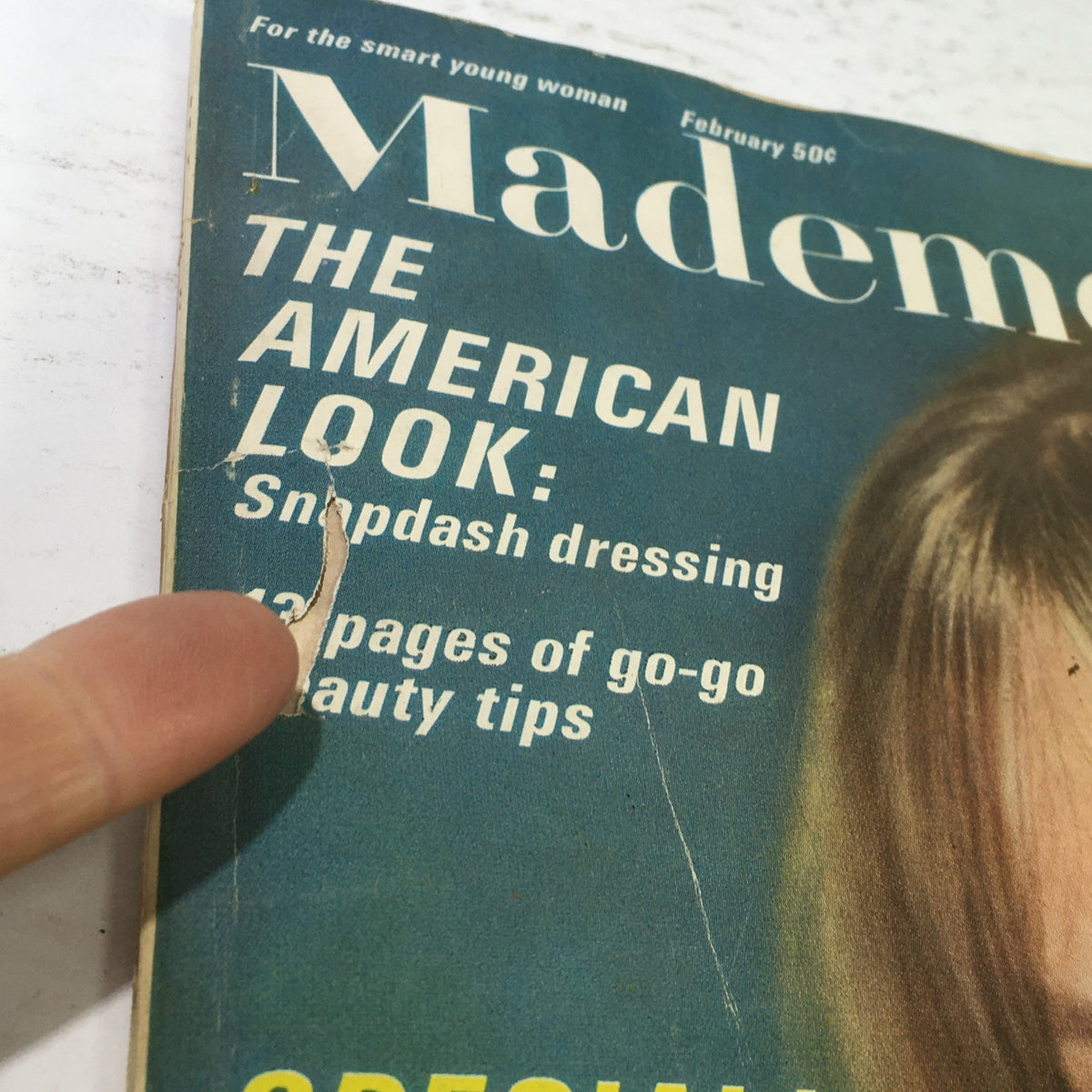 Cover detail of the vintage Mademoiselle Magazine from February 1966, featuring the title 'The American Look: Snapdash dressing' and emphasizing '14 pages of go-go beauty tips'.