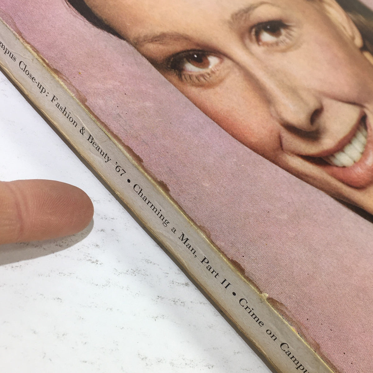 Close-up of the VTG Mademoiselle Magazine: August 1967 - College Issue, showing a woman's face and details about fashion and beauty articles from 1967.
