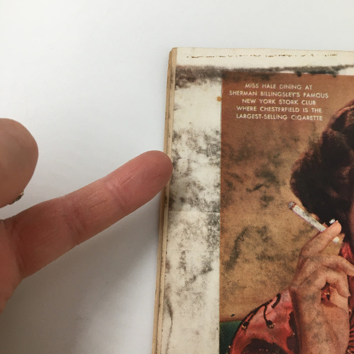Close-up of the edge of VTG Time Magazine January 23 1950 Vol. 55 No. 4, showing finger pointing at the text about Miss Hale dining at the Stork Club in New York.
