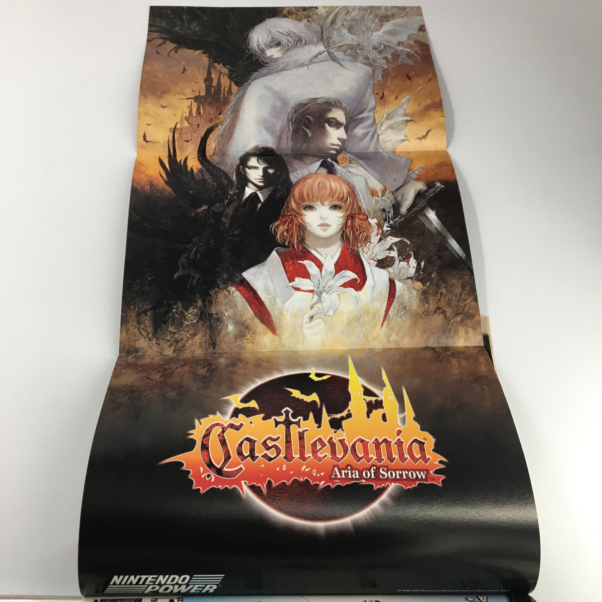 Promotional poster for Castlevania: Aria of Sorrow featured in Nintendo Power Magazine Vol 168, May 2003, showcasing stunning artwork and characters from the game.