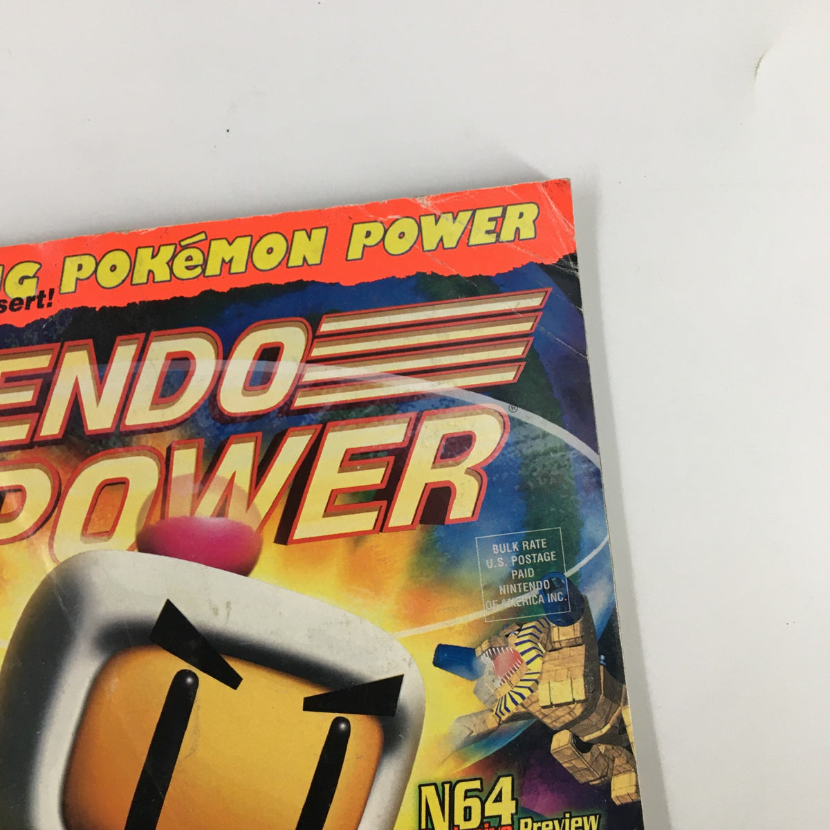 Cover image of Nintendo Power Magazine #111 from August 1998 featuring Bomberman Hero and a vibrant color scheme with Pokémon Power insert.