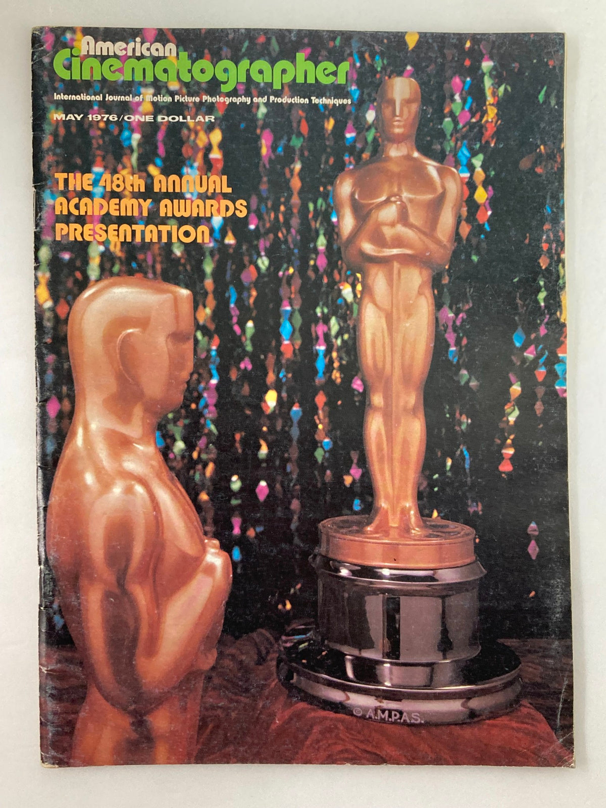 Cover of American Cinematographer Magazine May 1976 featuring two Oscars against a colorful background, celebrating the 48th Annual Academy Awards presentation.