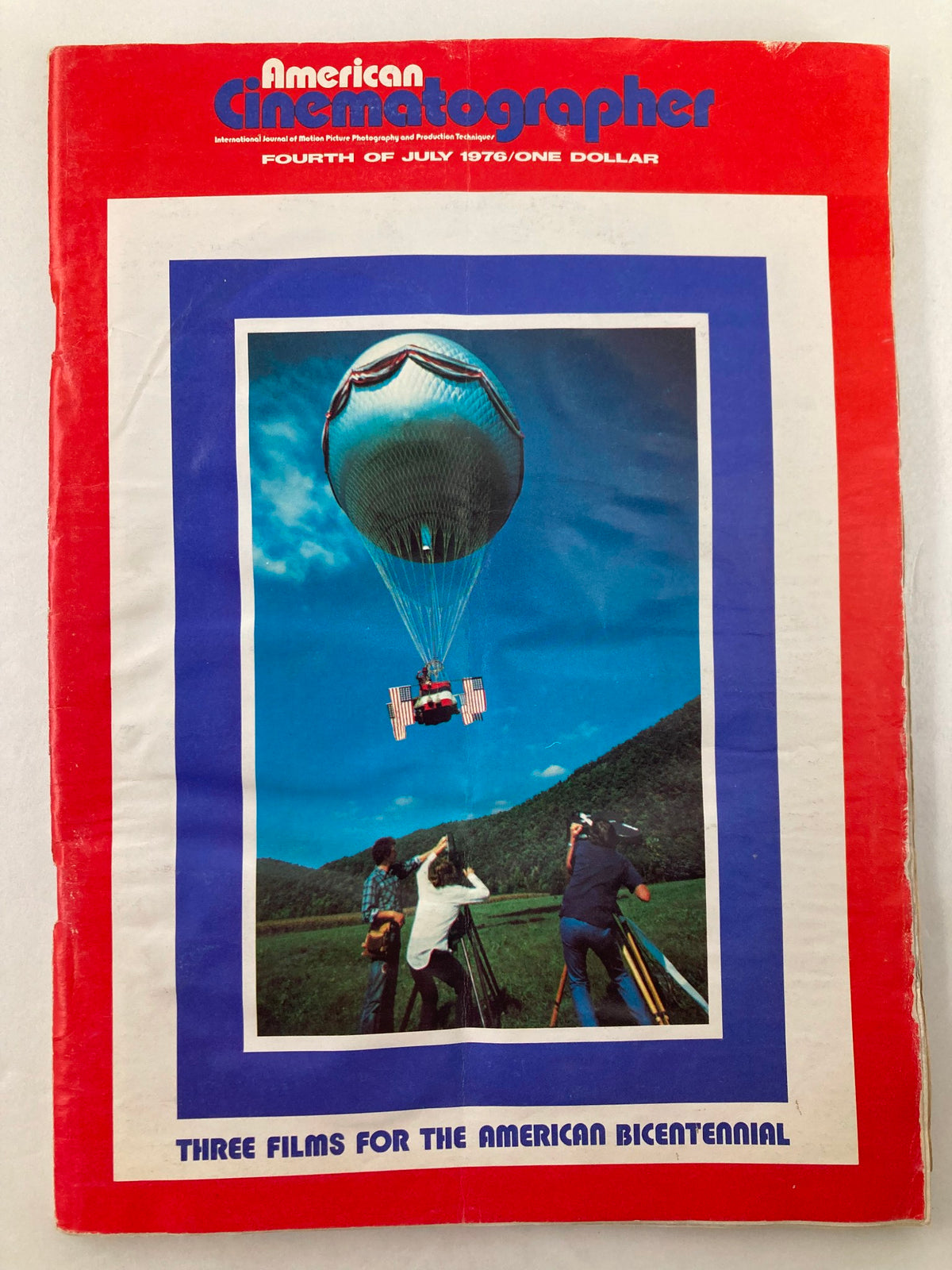 Cover of American Cinematographer Magazine July 1976 featuring a hot air balloon and filmmakers capturing a scenic shot, showcasing the artistry of cinematography.