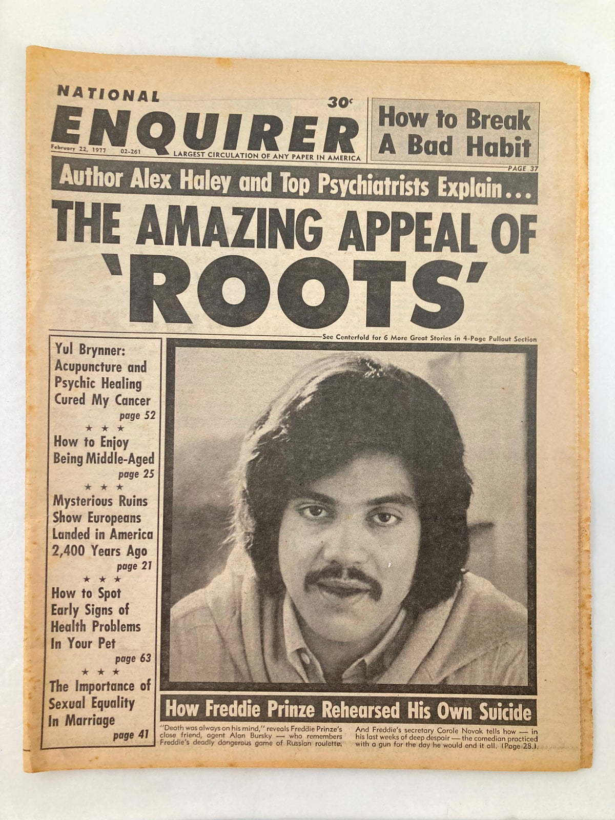 National Enquirer Tabloid from February 22, 1977 featuring the headline 'The Amazing Appeal of Roots' and an article on Freddie Prinze's rehearsed suicide. The image shows the tabloid cover with a portrait of Freddie Prinze.