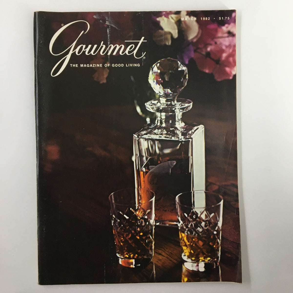 Cover of VTG Gourmet Magazine March 1982 featuring a crystal decanter and two glasses of whiskey, highlighting themes in culinary history and fine spirits.
