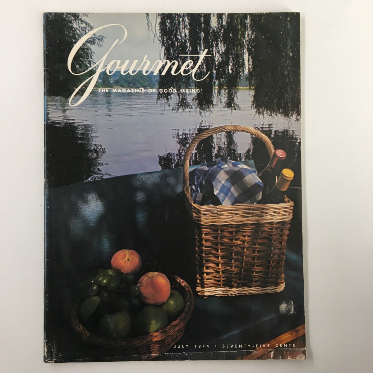 Cover of VTG Gourmet Magazine July 1974 featuring a picnic basket filled with food and wine by a serene lake, embodying summer picnic vibes.