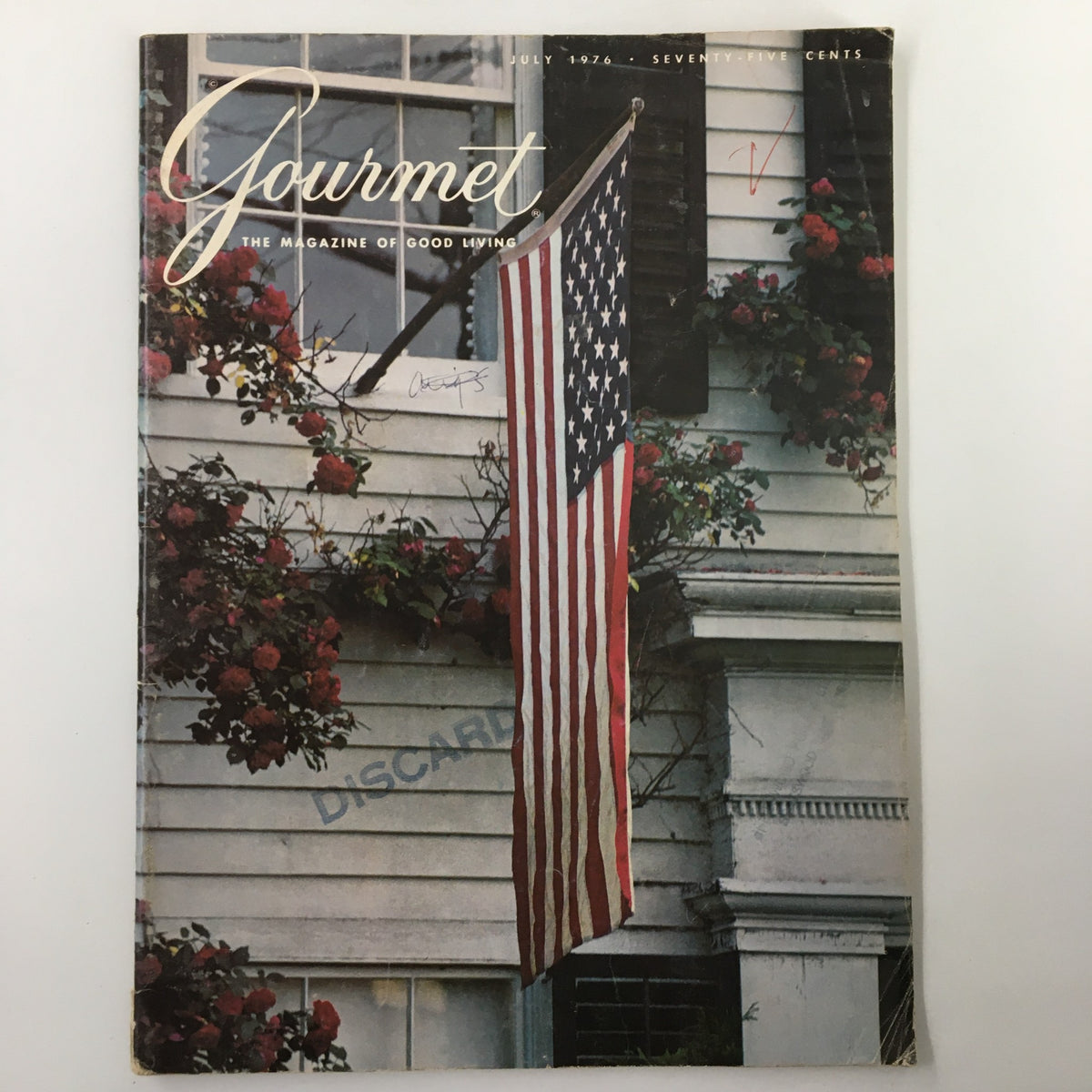 Cover of VTG Gourmet Magazine July 1976, featuring an American flag against a backdrop of flowers, highlighting the theme 'Flag-Waving As We Pay Tribute'.