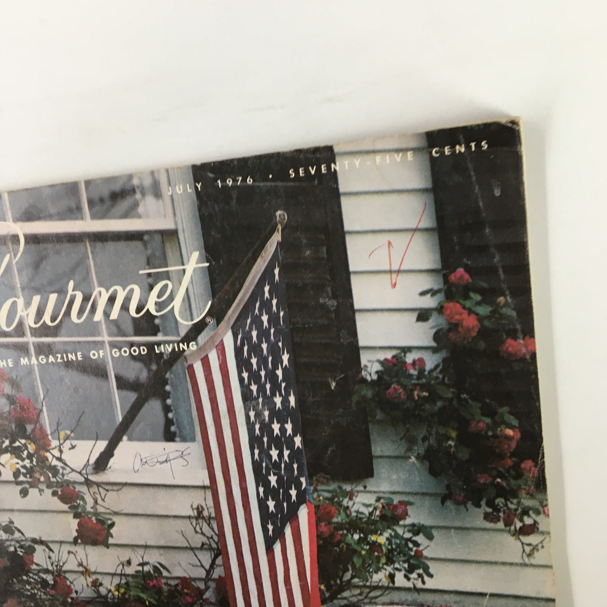 Close-up of the cover of VTG Gourmet Magazine July 1976, showcasing the title and an American flag with floral accents, themed 'Flag-Waving As We Pay Tribute'.