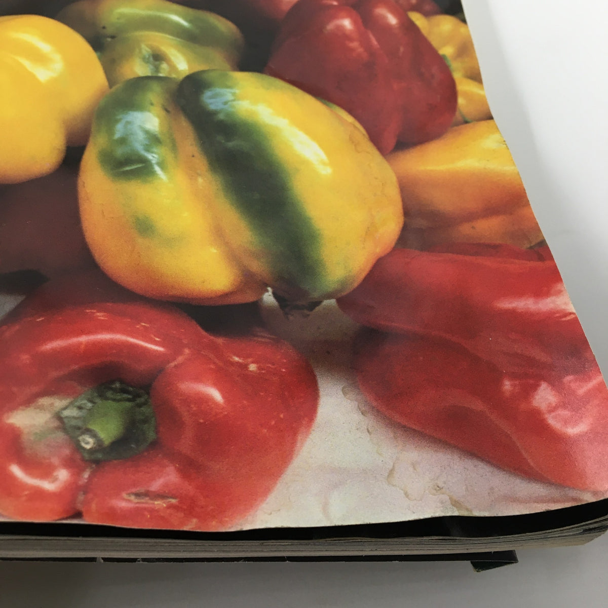 Close-up image of shiny bell peppers from the cover of VTG Gourmet Magazine May 1984.