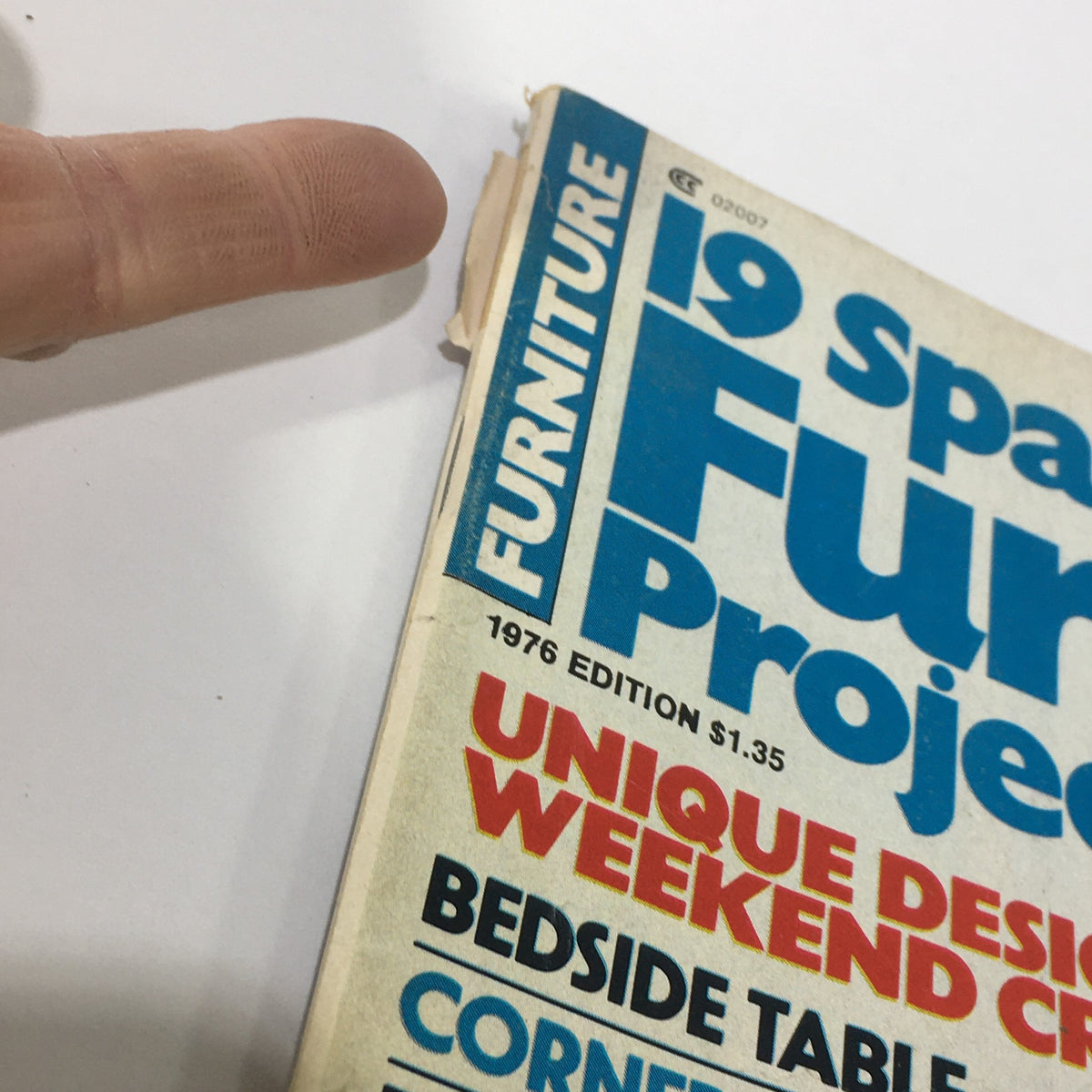 Close-up of the 1976 edition cover of the Vintage Furniture Projects Magazine, showing wear and tear, reflecting its vintage status among furniture design enthusiasts.