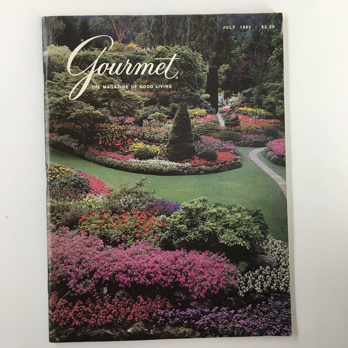 Cover of VTG Gourmet Magazine July 1982 featuring vibrant floral gardens and lush greenery, highlighting the horticultural appeals of Victoria.