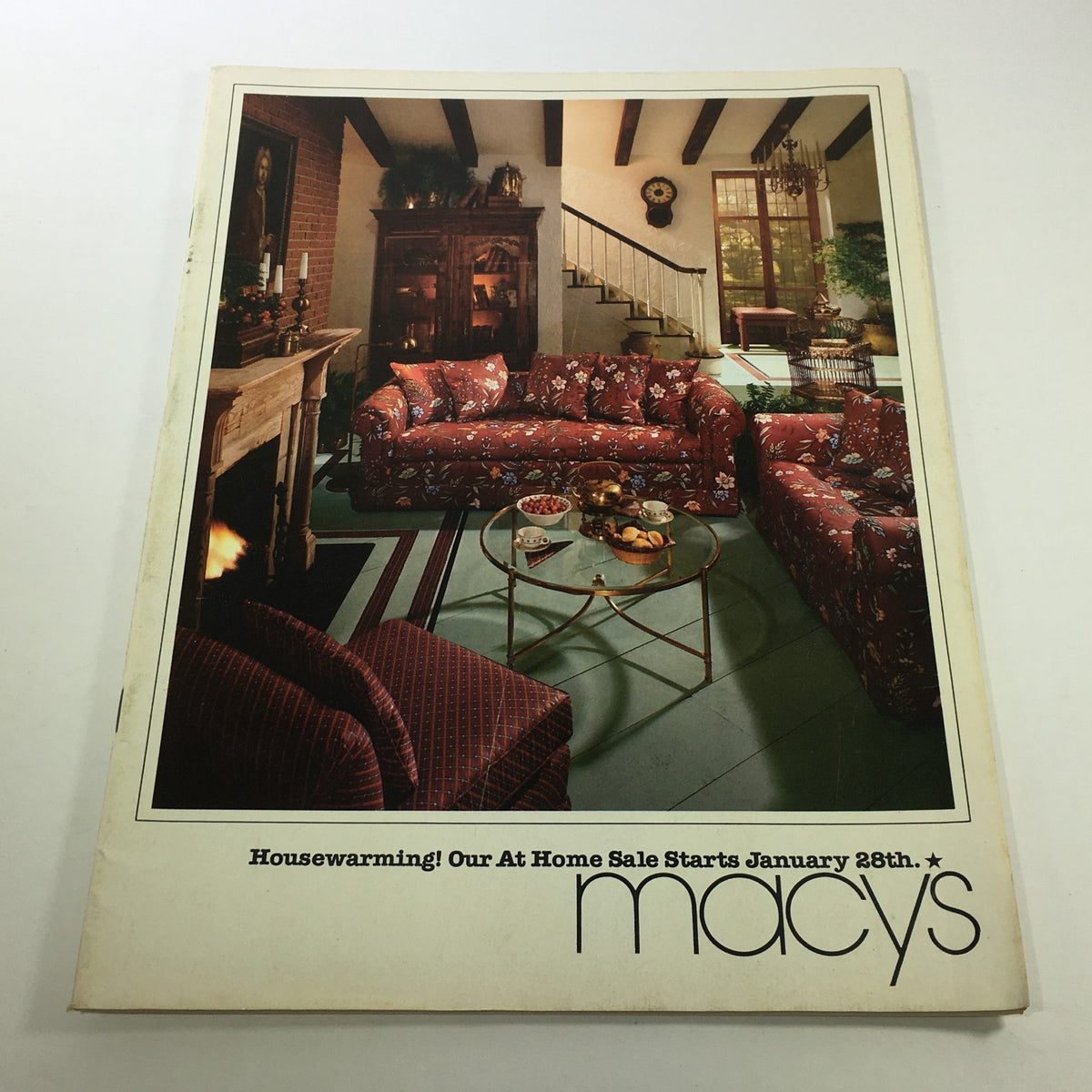 VTG Macy's Catalog from February 1979 featuring a housewarming price list, showcasing a stylish living room setup with floral patterned furniture and decorative elements.