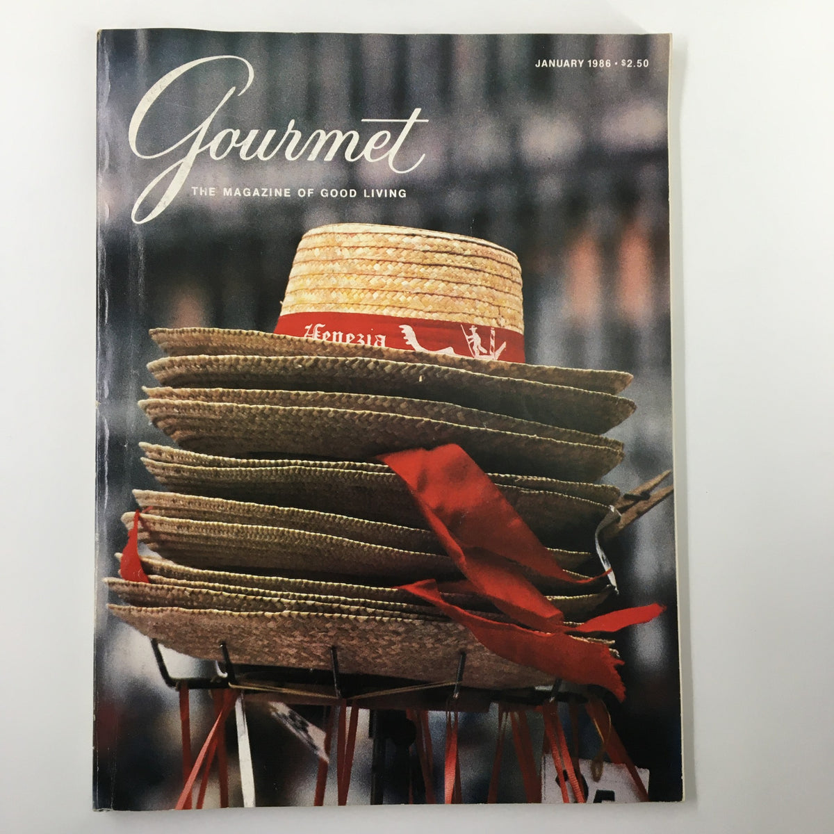 Cover of Gourmet Magazine January 1986 featuring stacks of gondolieri hats decorated with red ribbons, showcasing culinary culture.