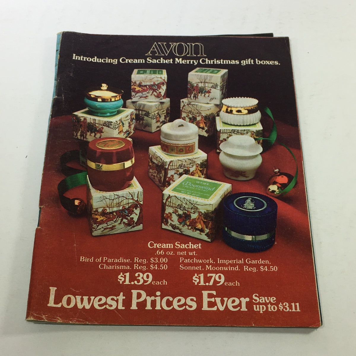 VTG Avon Catalog: 1974 - Fashion Accessory Brochure featuring Christmas gift boxes with Cream Sachets, showcasing multiple decorative containers on a festive background. Lowest Price / No Label.