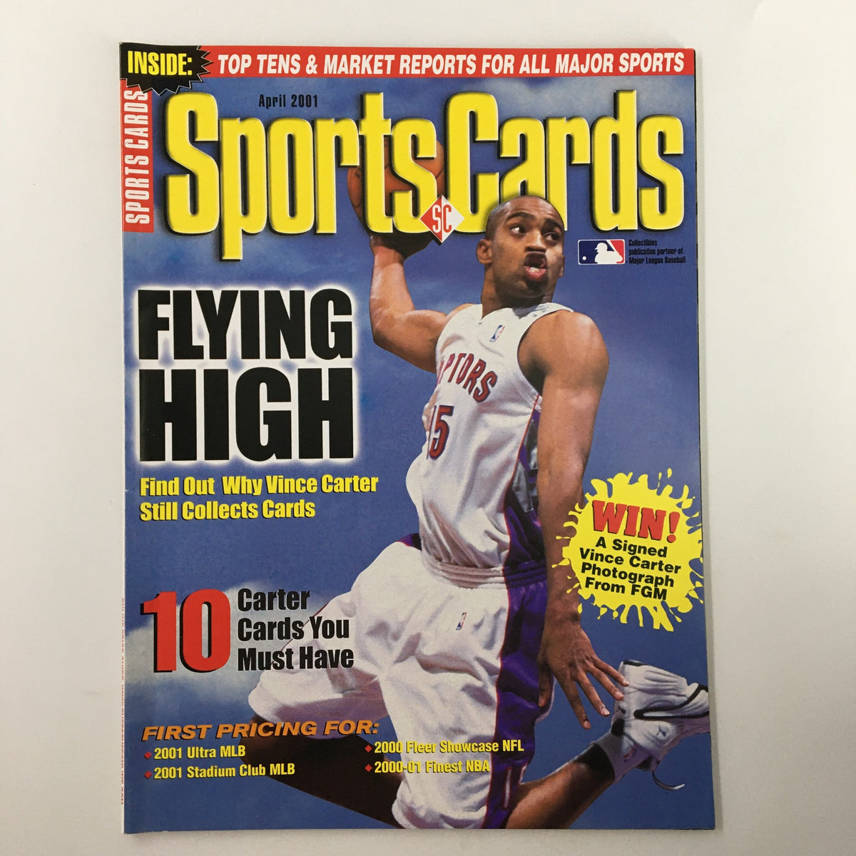 Cover of Sports Cards Magazine, April 2001, featuring NBA star Vince Carter in Toronto Raptors gear, showcasing the headline 'Flying High' along with details about card collecting and a promotional offer for signed memorabilia.