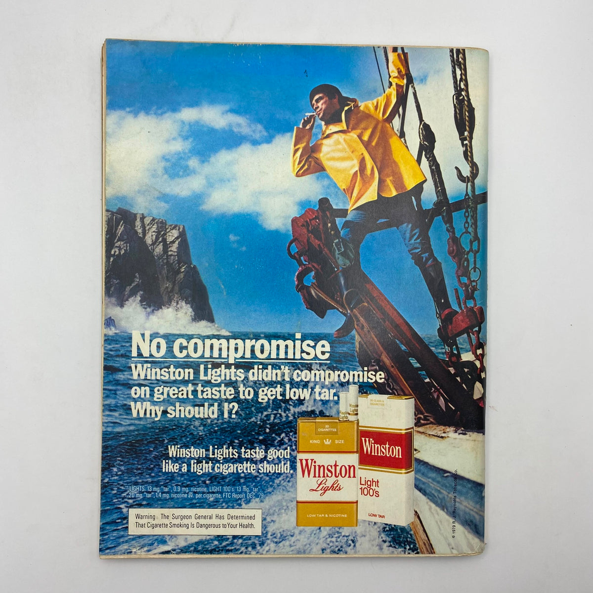 Advertisement from Playboy Magazine July 1980 for Winston Lights cigarettes, showcasing a man on a fishing boat with a striking ocean backdrop.