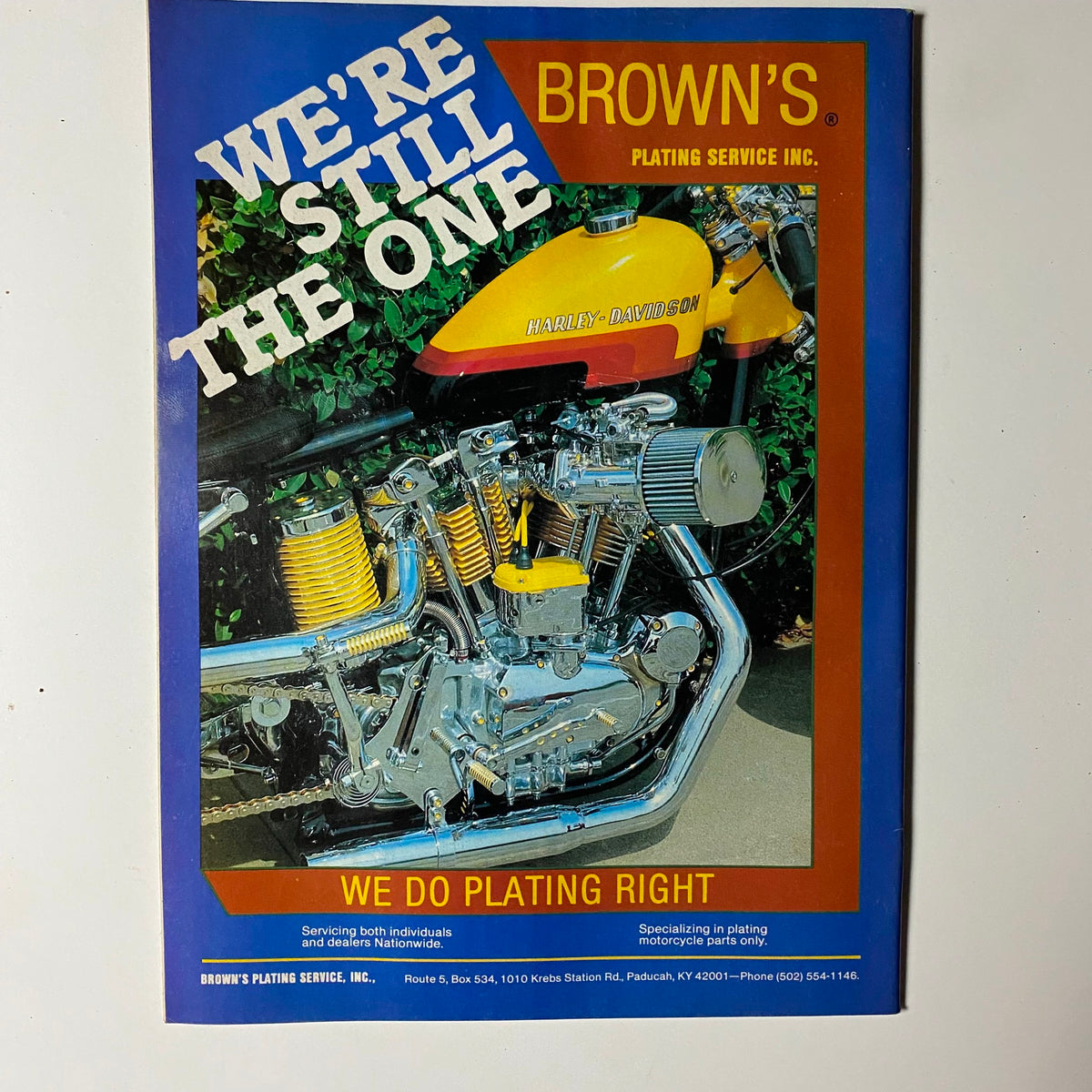 Ad page from VTG Biker Lifestyle Magazine December 1984, displaying a Harley-Davidson motorcycle with a vibrant background, promoting Brown's Plating Service.