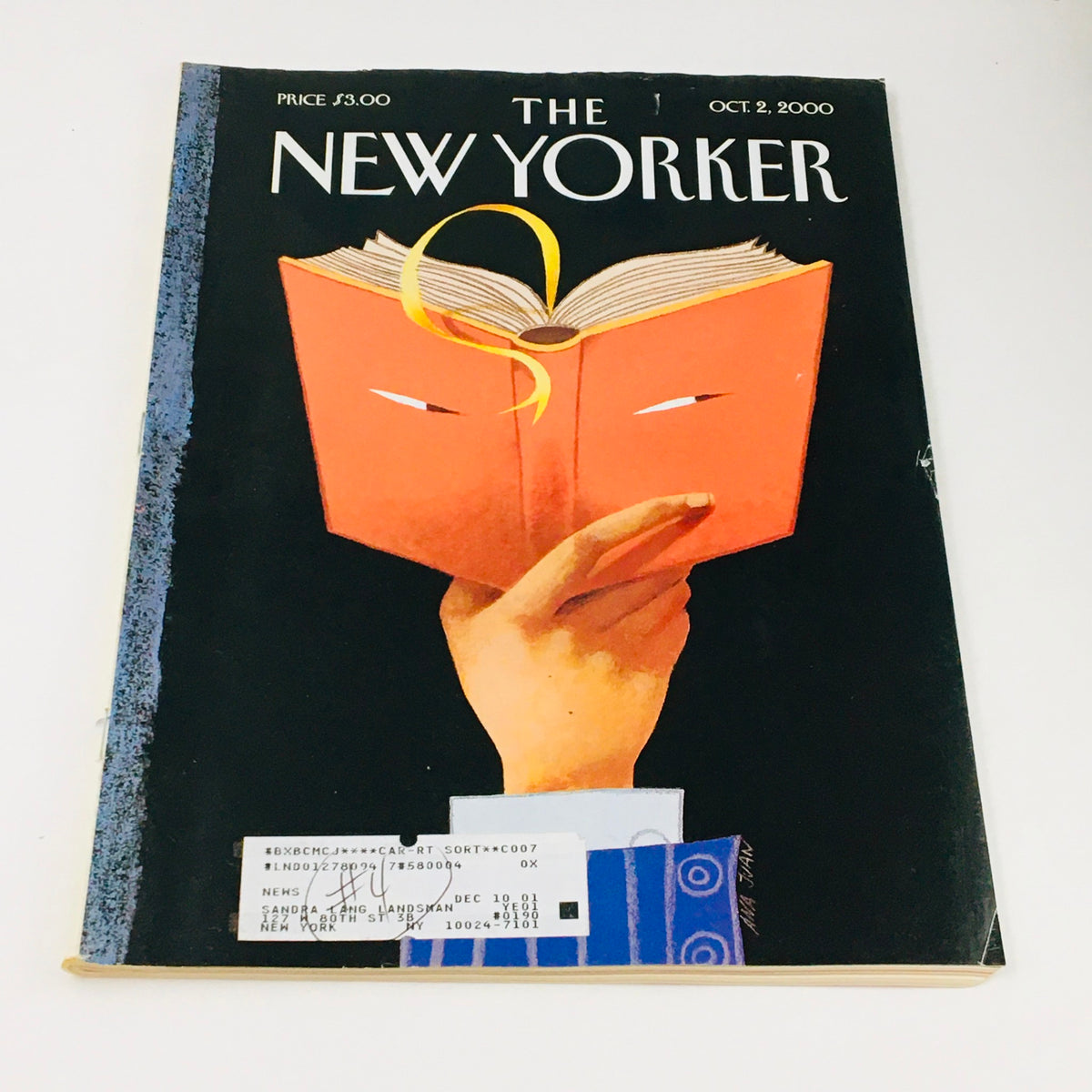 The New Yorker October 2 2000 Full Magazine Theme Cover by Ana Juan depicting a hand holding an open book with a striking orange cover design.