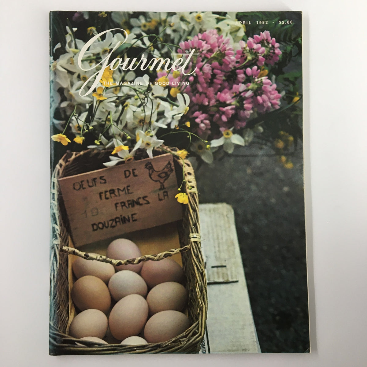 Cover of VTG Gourmet Magazine April 1982 featuring a basket of farm-fresh eggs and vibrant spring flowers, titled 'Nest Arrive in Style in Aubenas'.