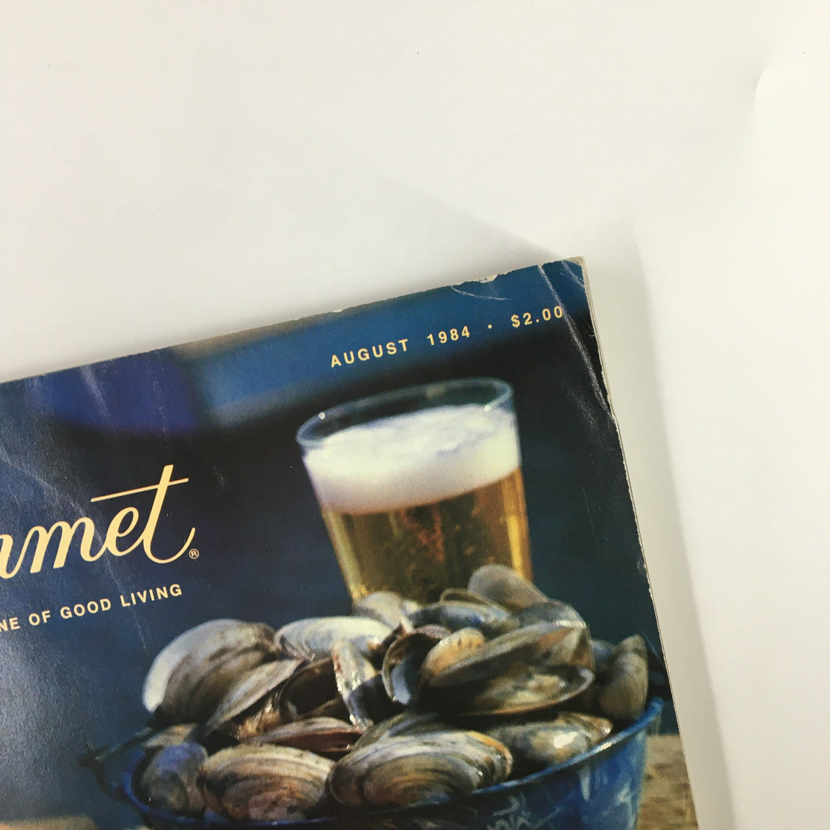 Close-up of the cover of VTG Gourmet Magazine August 1984, highlighting steamed clams and a cold beer, emphasizing the gourmet dining theme.