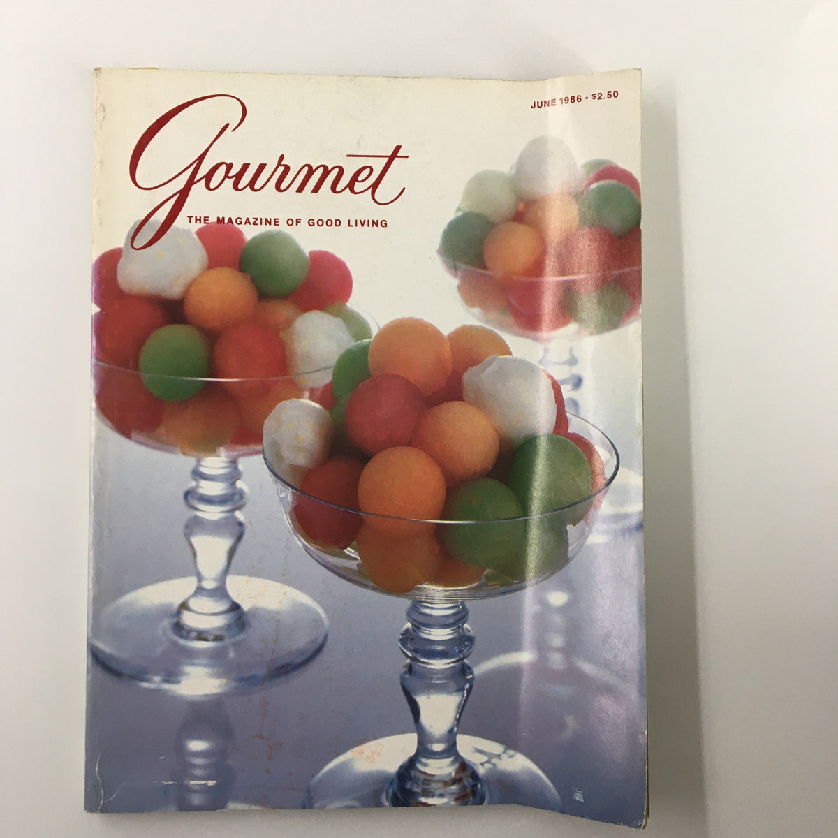 Cover of VTG Gourmet Magazine June 1986 featuring colorful melon balls in glass dessert bowls, showcasing summer culinary trends.