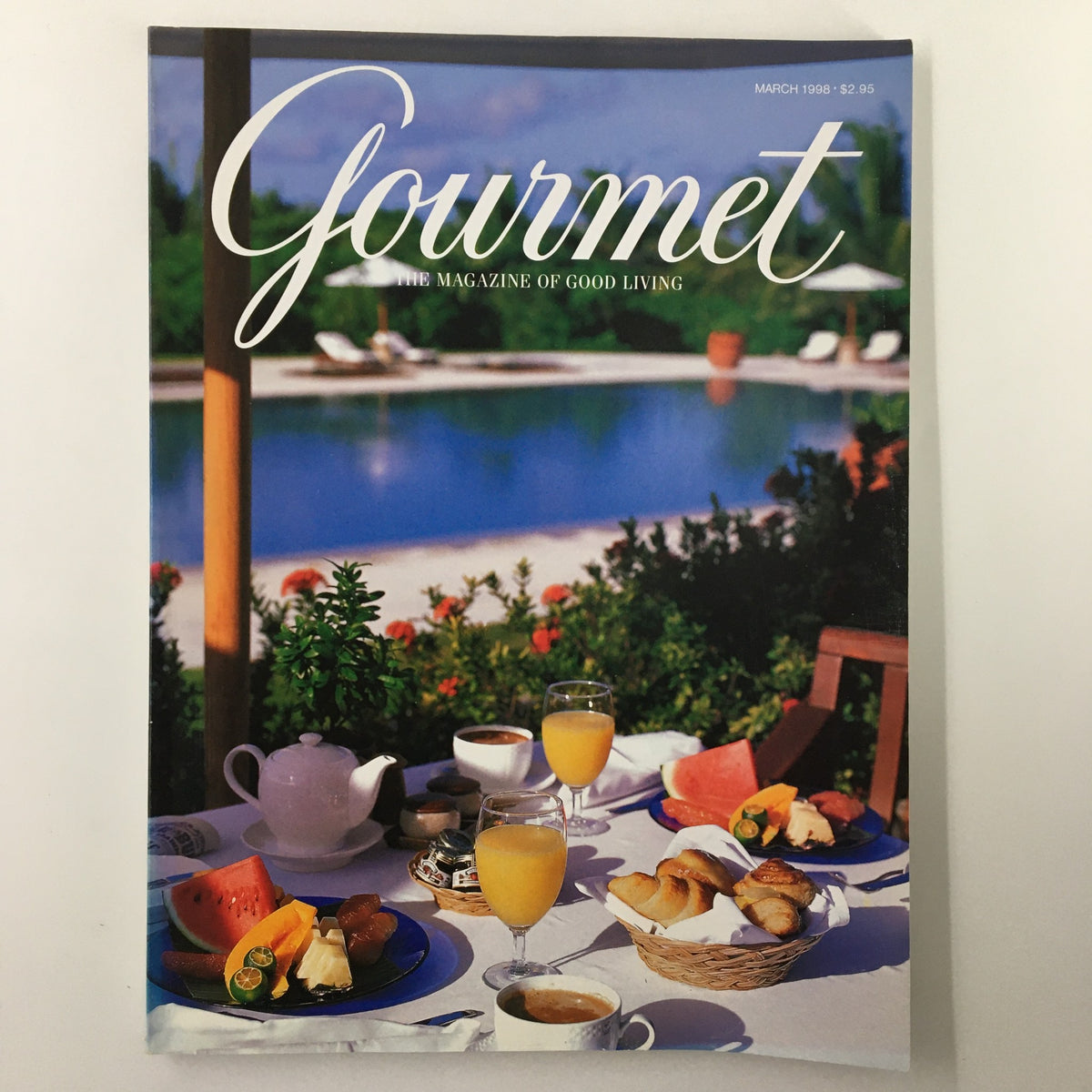 Cover of Gourmet Magazine March 1998, featuring a beautifully arranged breakfast setting by a pool with fruits, pastries, and beverages, symbolizing the theme 'Less is More: Dinner on the Light Side'.