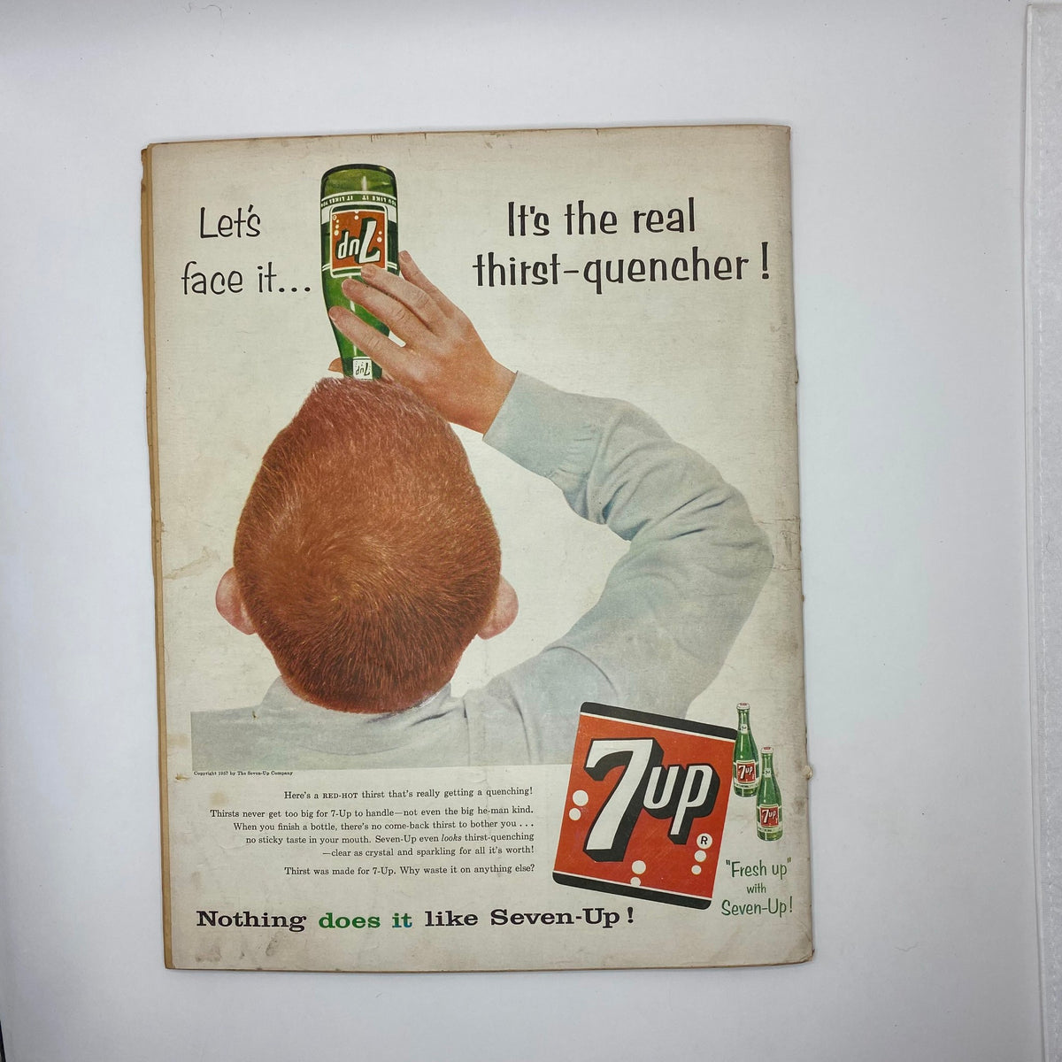 Back cover of the VTG Boys' Life for All Boys Magazine, April 1957, displaying a vintage advertisement for 7-Up, featuring a boy enjoying the drink, illustrating the nostalgic marketing of the era.