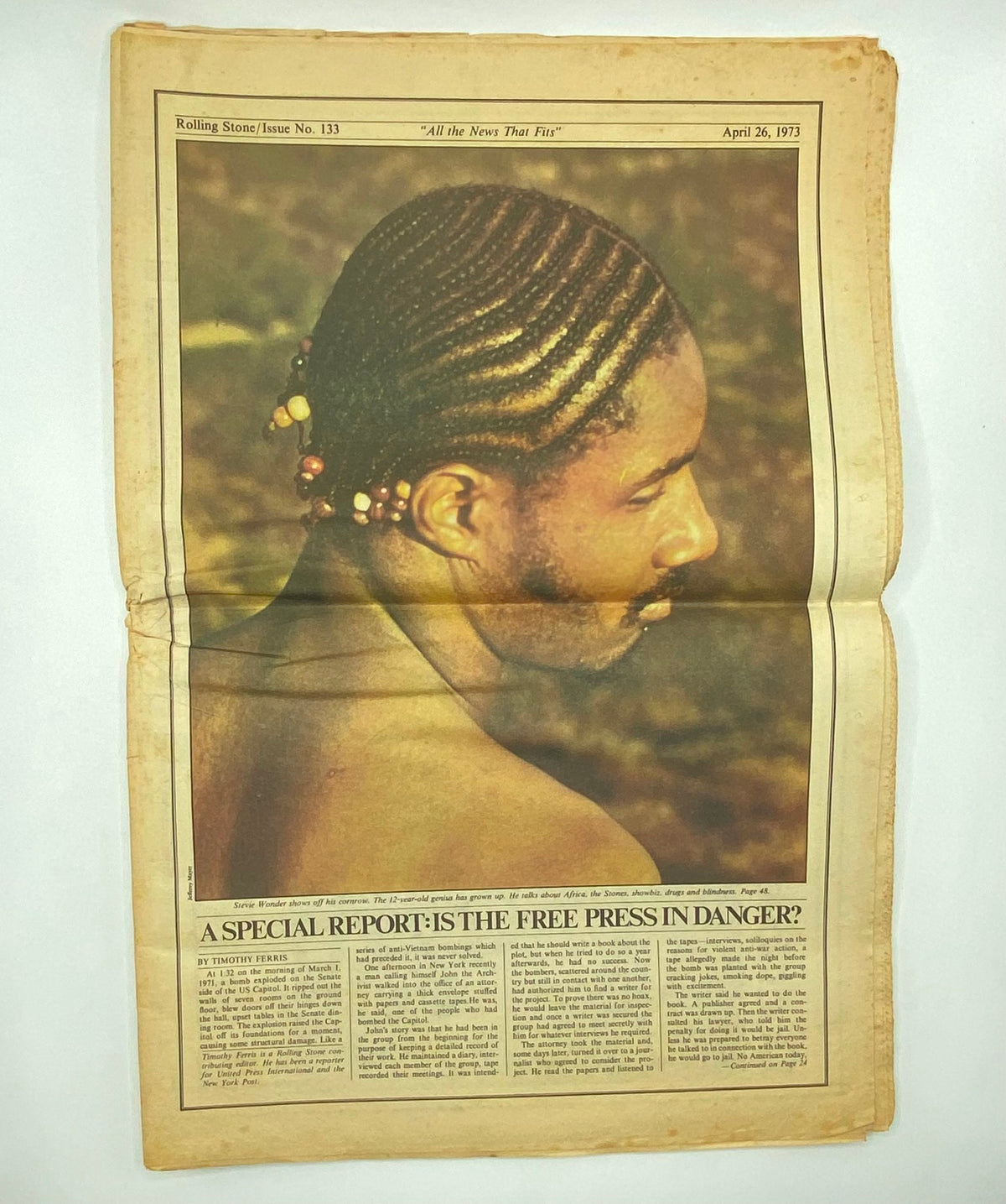 Inside page of Rolling Stone Magazine, April 26, 1973, Issue No. 133 featuring a photograph of a man with braided hair, along with a discussion on freedom of the press, highlighting the journalistic themes of the era.