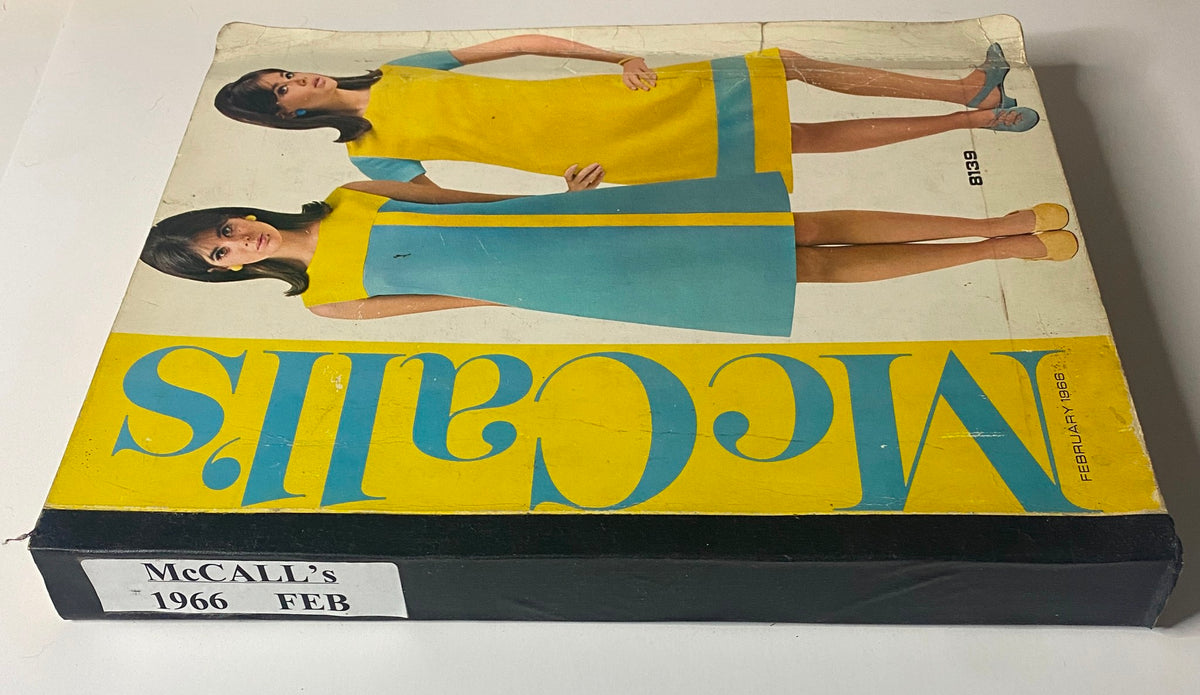 Side view of the 1966 February McCall's Designers' Collection catalog showcasing two women in vibrant blue and yellow dresses, emphasizing the stylish designs from the era.