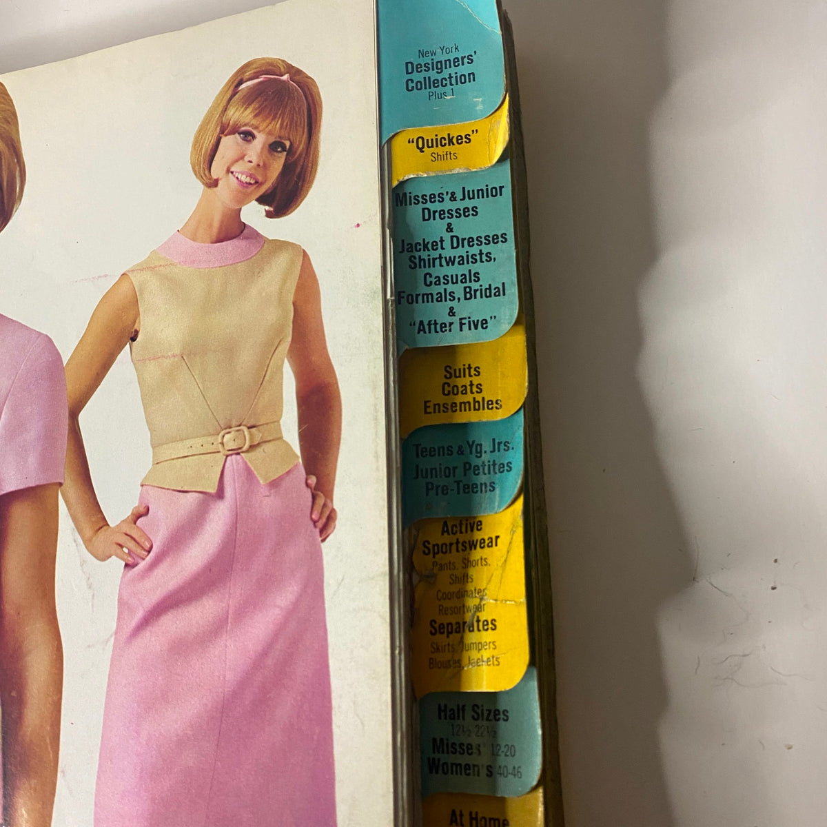 Cover of the 1966 February McCall's Designers' Collection Catalog showcasing a model in a stylish pink and yellow outfit, highlighting categories like 'Quickies' shifts, and Misses' and Junior Dresses.