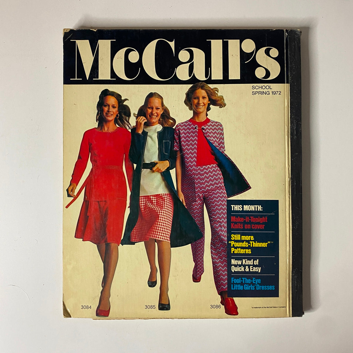 Cover of the 1972 McCall's School Spring Huge Store Retail Counter Catalog featuring three models in stylish outfits, highlighting youthful fashion trends of the era.