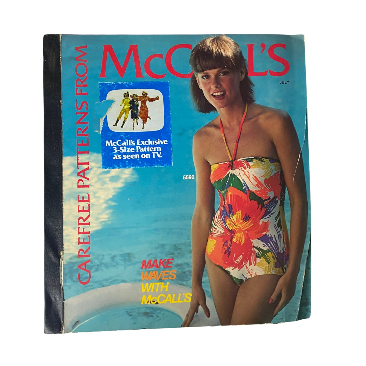 1977 July Carefree Patterns McCall's Catalog cover featuring a model in a colorful swimsuit, advertising McCall's exclusive sewing patterns for summer fashion.