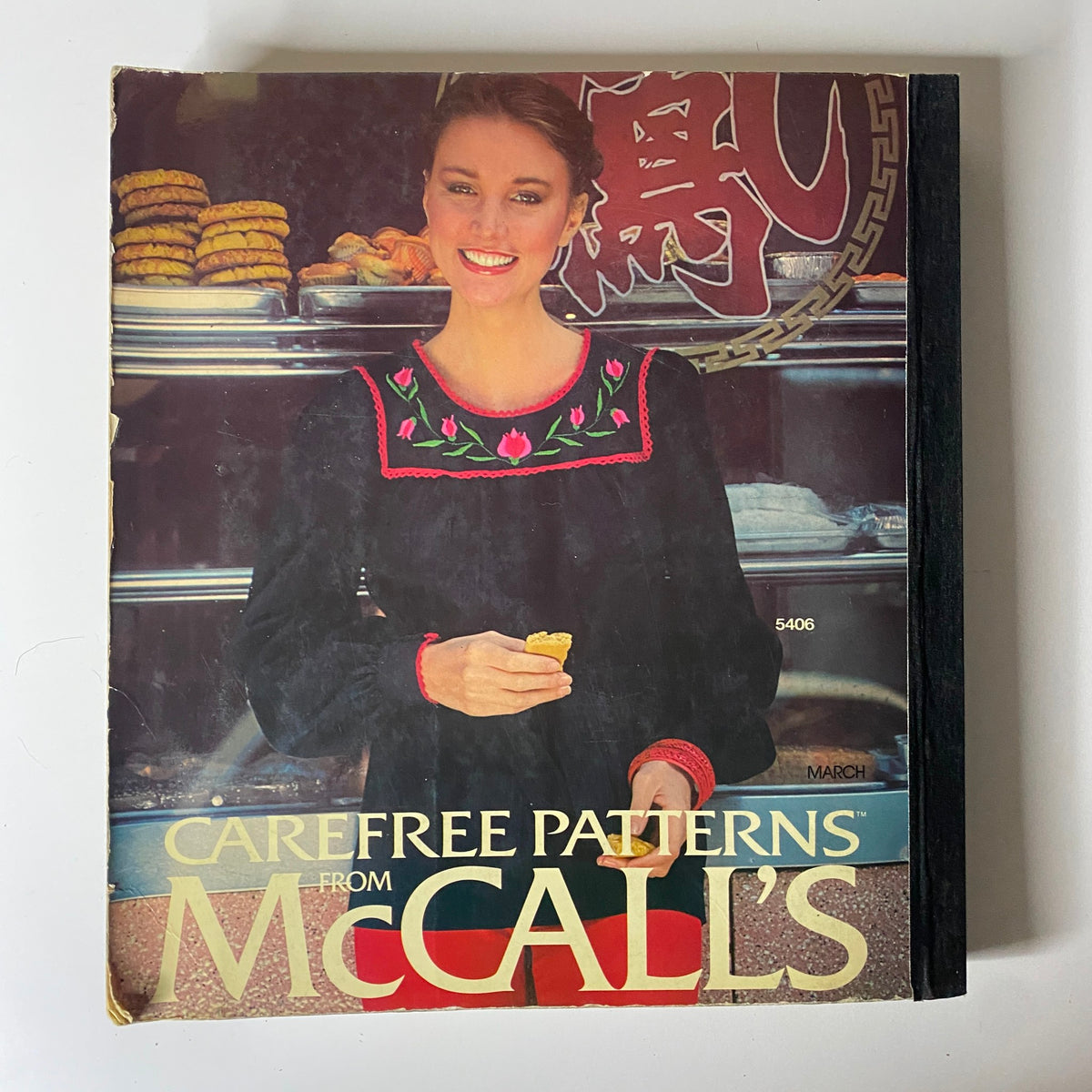 1970s March Carefree Patterns from McCall's Catalog featuring a vintage black dress with embroidery, highlighting the classic and timeless design of 1970s fashion.