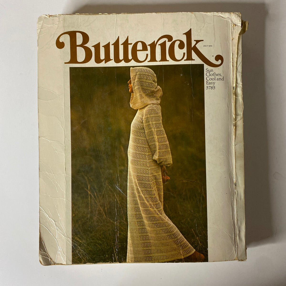 Cover of the 1970 July Butterick Catalog, showcasing a unique sun dress design, reflecting the cool and easy styles of the era.