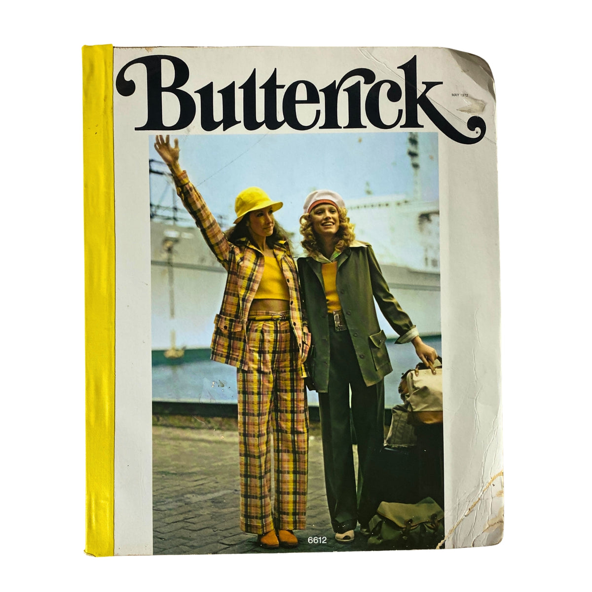 Cover of the 1972 May Butterick Catalog featuring stylish women's fashion, including two models wearing vibrant outfits and accessories, showcasing the essence of 1970s fashion.