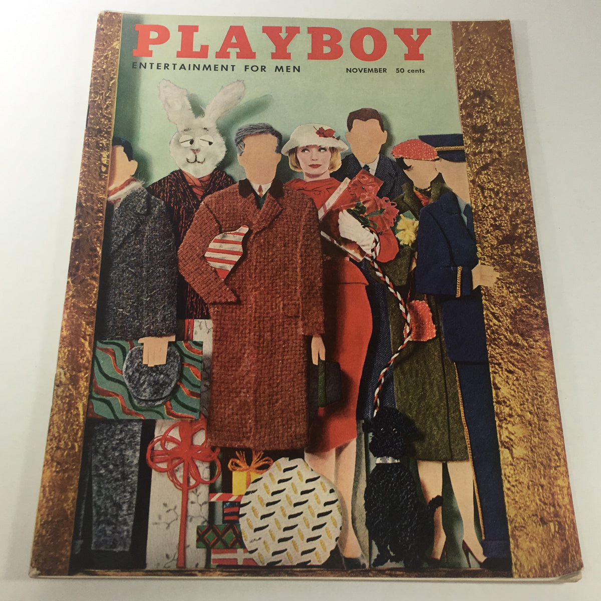 VTG Playboy Magazine: November 1956 - Betty Blue Playmate cover featuring a colorful and artistic illustration of models in vintage attire, showcasing playful elements like a rabbit mask and a scotty dog, capturing the playful and stylish essence of 1950s fashion.