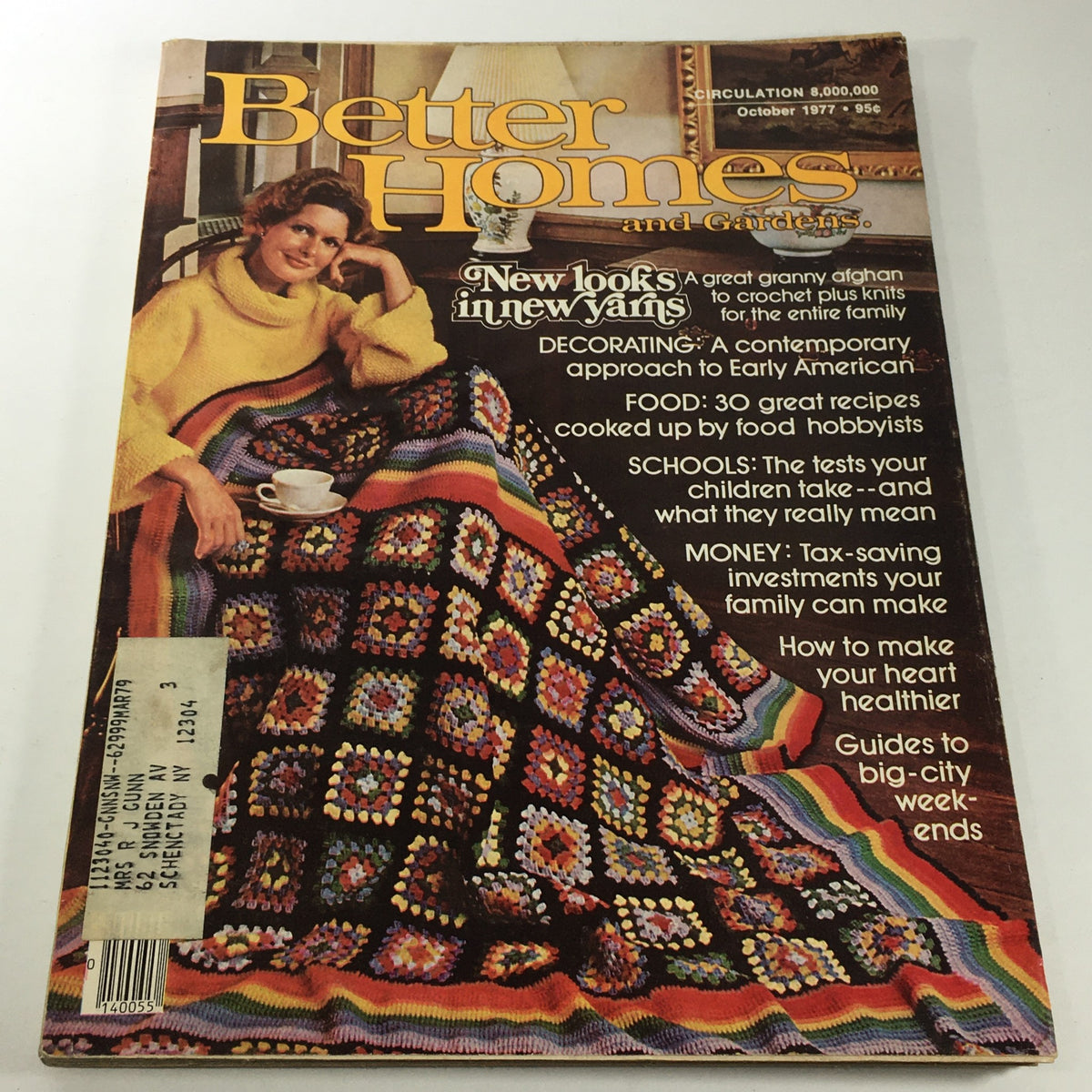 Cover of Better Home & Gardens Magazine, October 1977, featuring the title 'New Looks In New Yarns'. The image showcases a woman in a vibrant granny square afghan, exuding warmth and creativity in home decor. This vintage magazine reflects the crafting trends of the late 1970s, appealing to collectors and enthusiasts of retro home improvement.