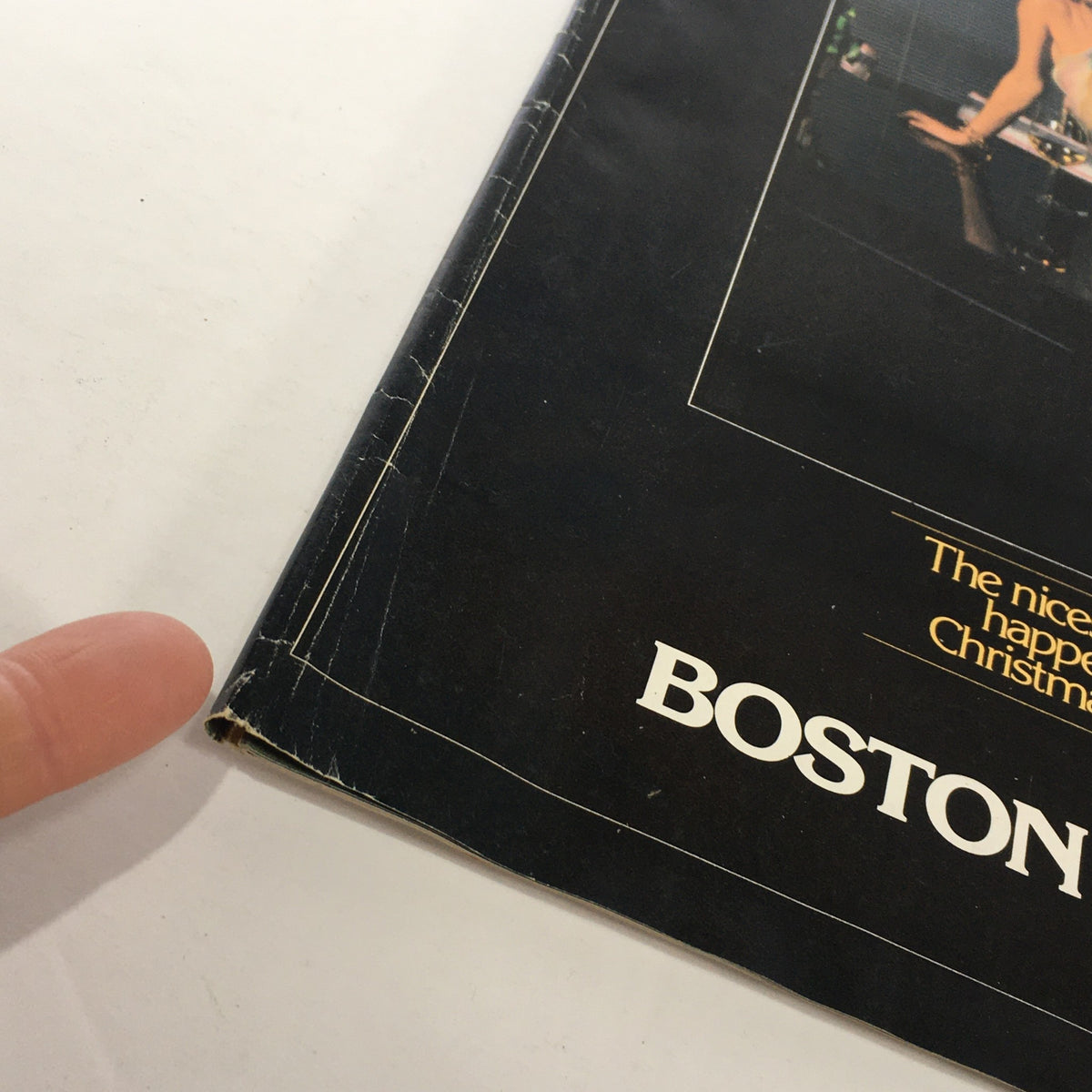 Detailed view of the cover of the VTG Boston Store Catalog December 1970s highlighting wear with text emphasizing Christmas.