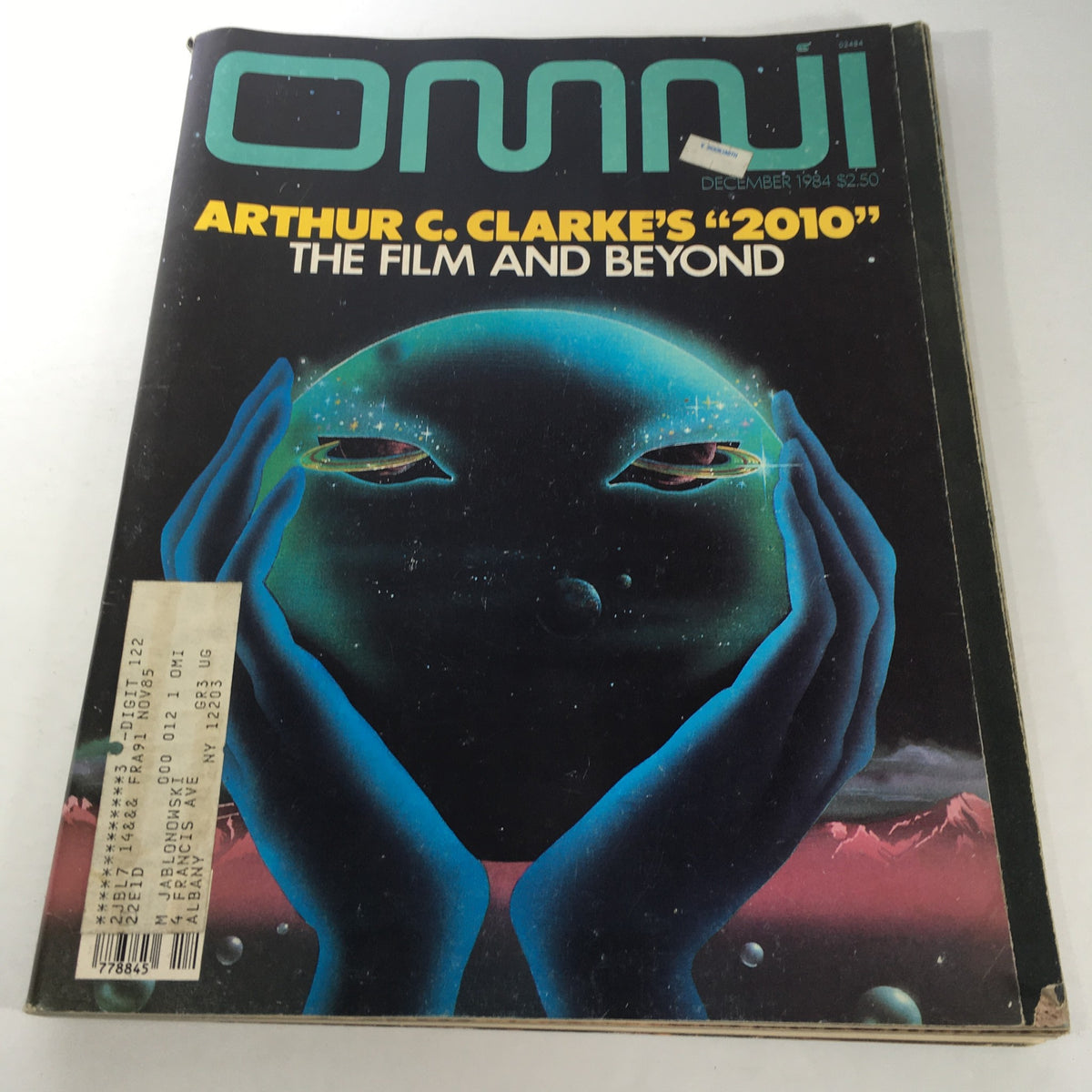 Cover of Omni Magazine December 1984 featuring Arthur C. Clarke's '2010' The Film and Beyond with an illustration of a cosmic scene and abstract hands.