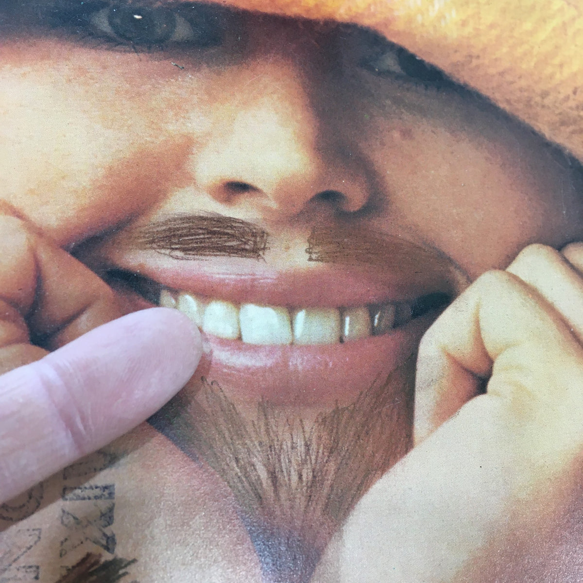 Detailed view of the cover of VTG American Girl Magazine March 1975 highlighting the girl's smile and facial features, with playful marks that add to the magazine's nostalgic appeal.