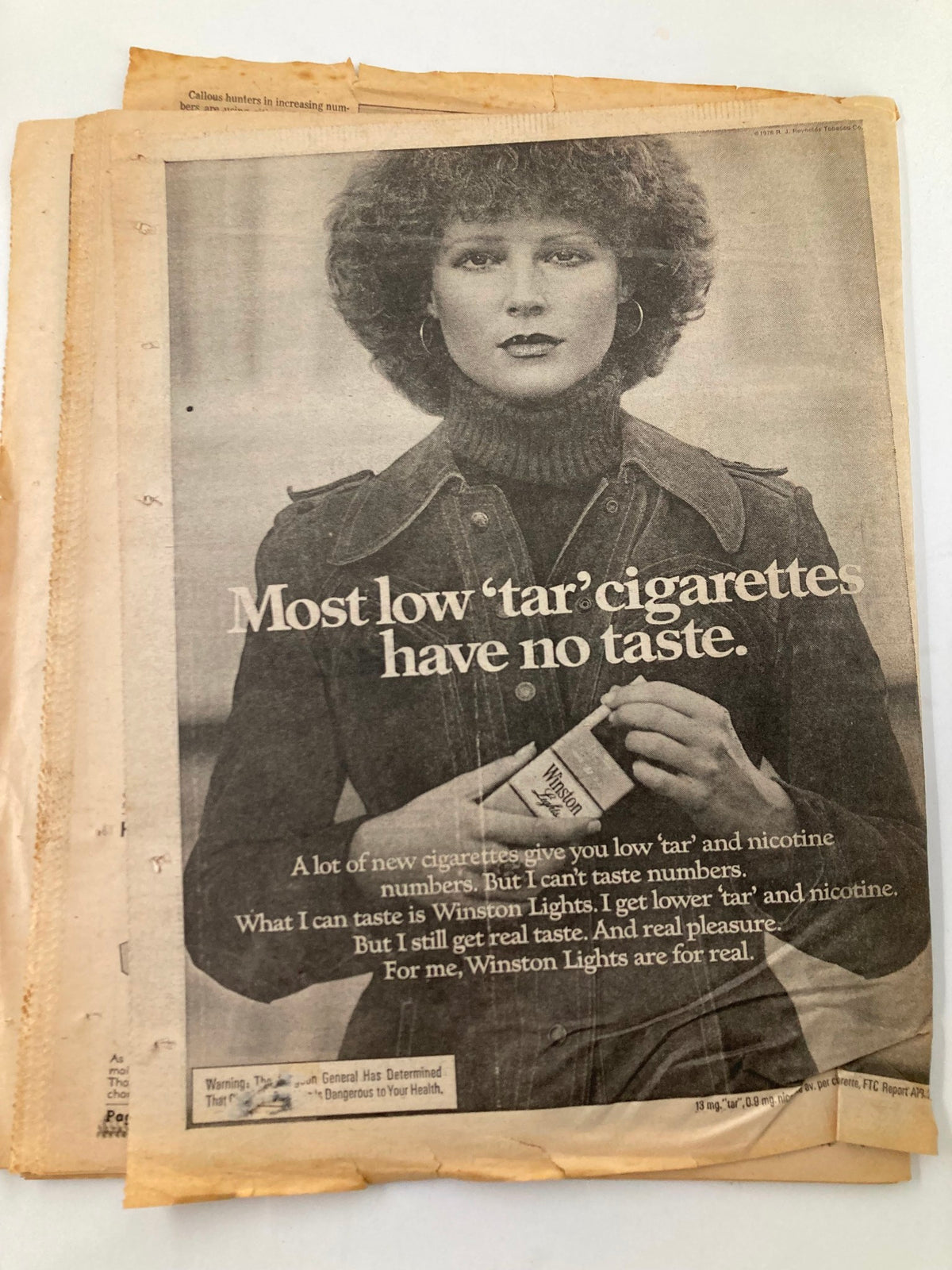 National Enquirer Tabloid October 26 1976 showcasing a vintage advertisement for Winston Lights cigarettes, emphasizing low tar and nicotine content.