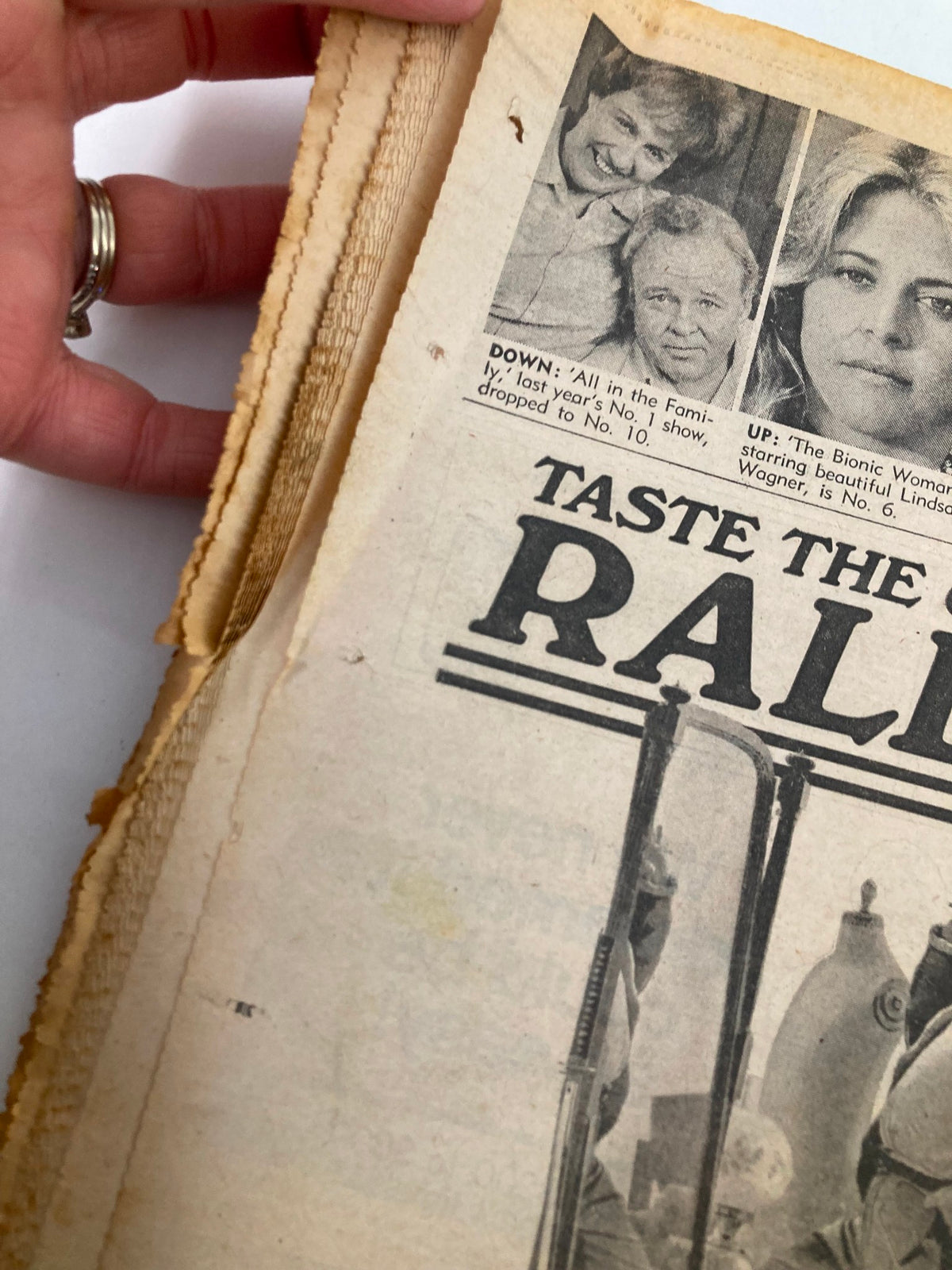 Interior view of the National Enquirer Tabloid dated February 15, 1977, showing pages related to 'Taste the Good Times' alongside images of celebrities, emphasizing its vintage appeal.
