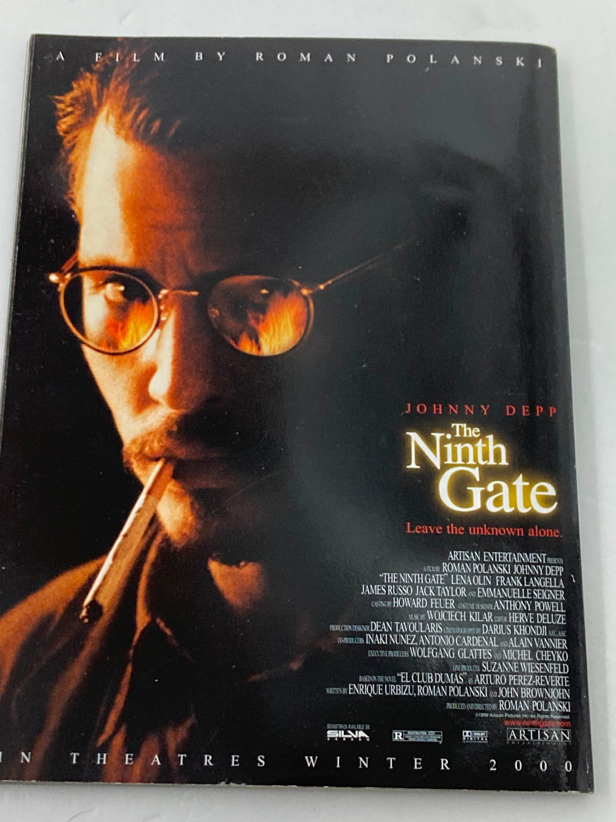 Promotional poster for 'The Ninth Gate', a film by Roman Polanski, showing Johnny Depp, presented within The X-Files Yearbook 2000.