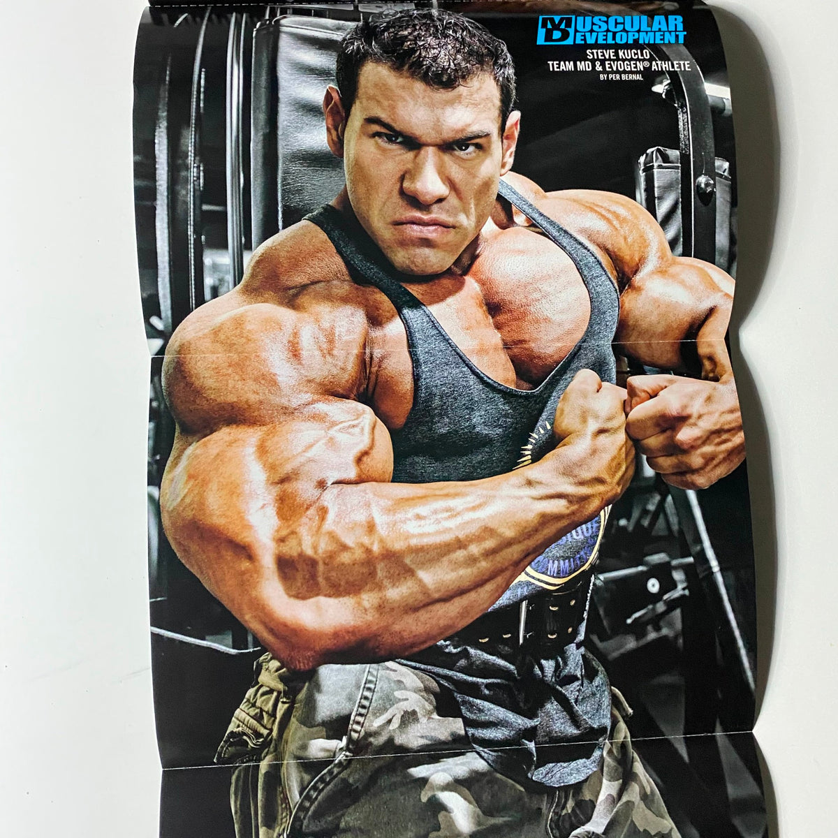 Poster from Muscular Development Magazine September 2012, depicting bodybuilder Stephen Kuclo in a muscular pose, ideal for fitness and bodybuilding decoration.