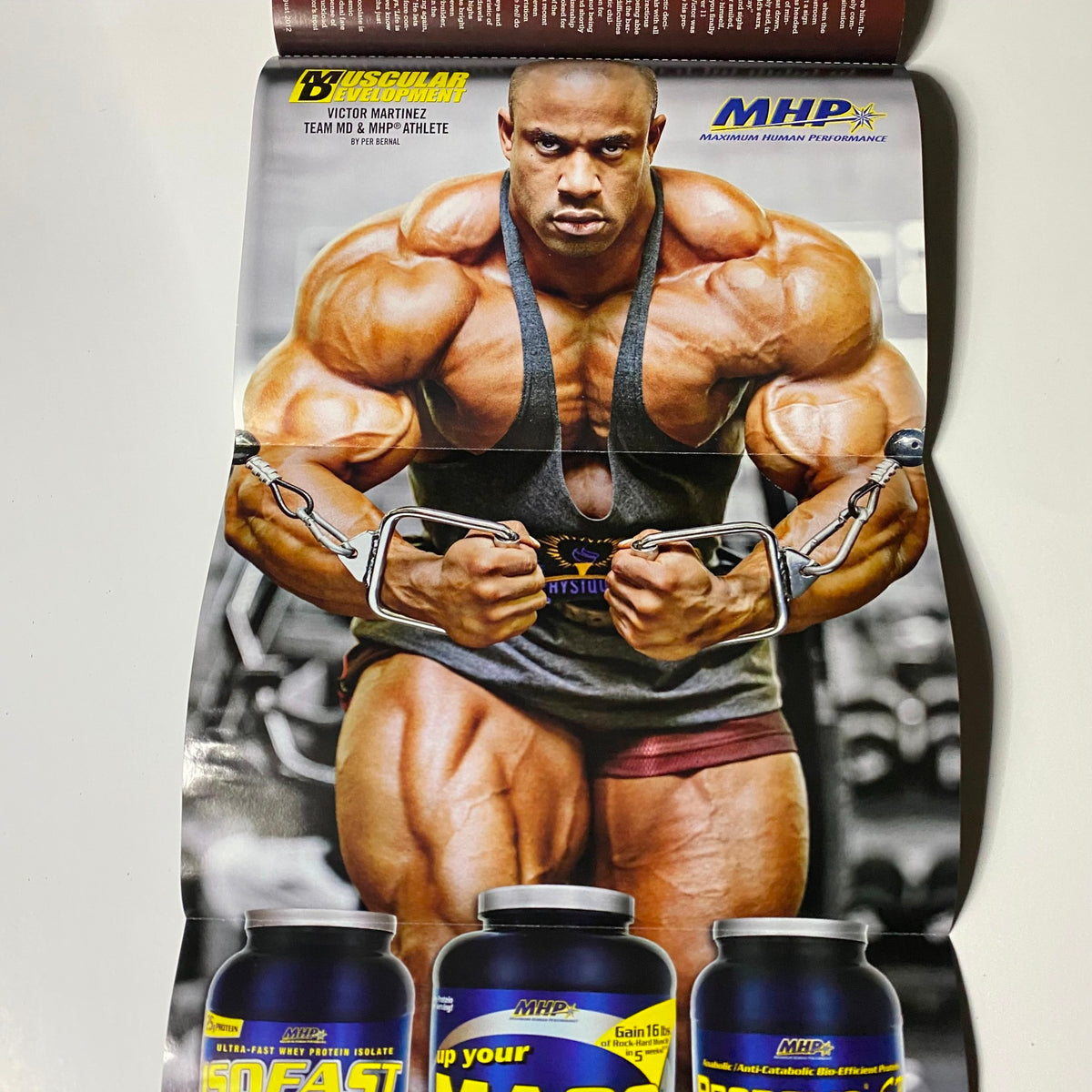 Inside poster from Muscular Development Magazine August 2012 showcasing Victor Martinez in a bodybuilding pose, promoting fitness and nutrition products.