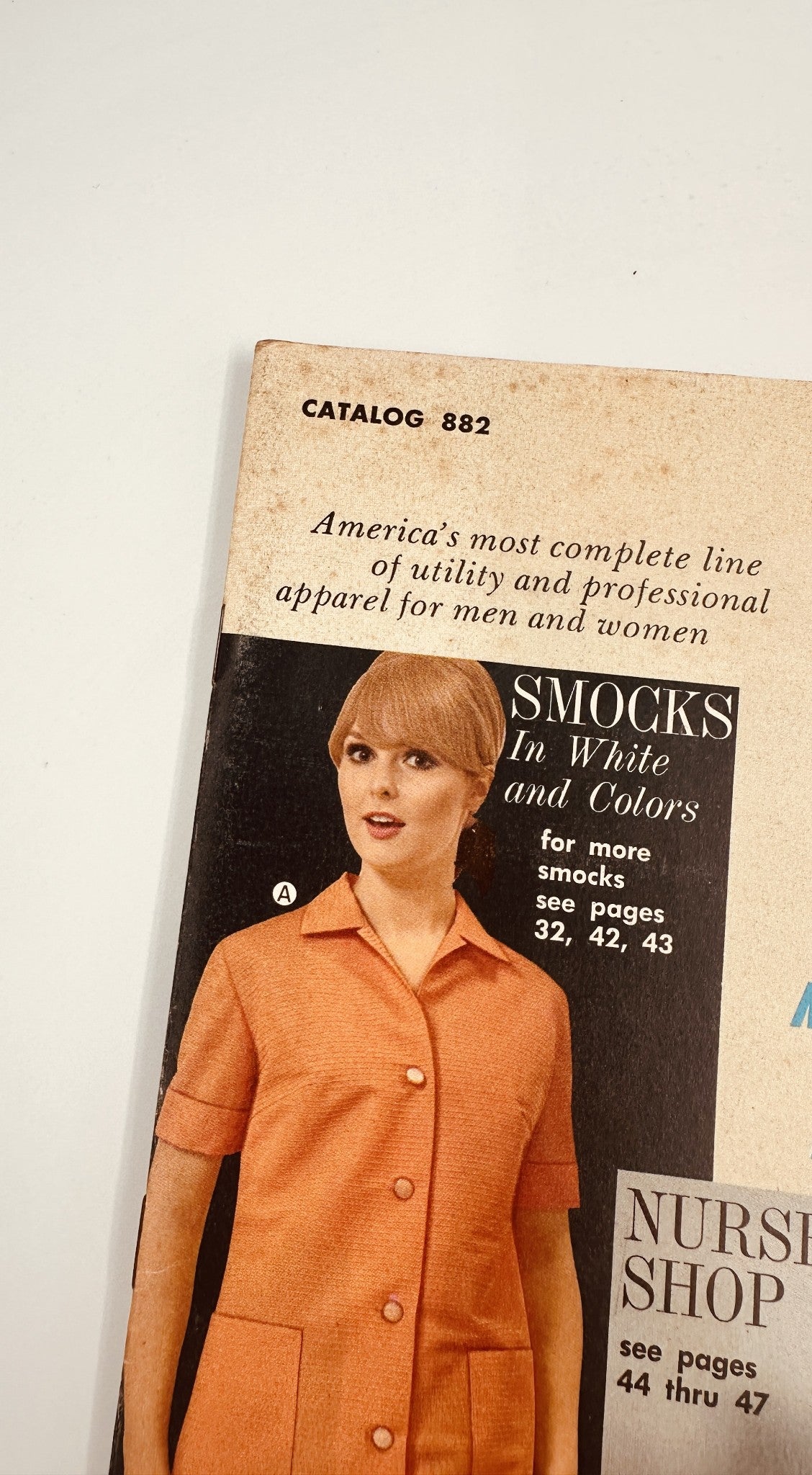 James G. Fast Catalog 1968 Nurse Uniforms Smocks Medical Apparel featuring a woman in a classic orange smock, showcasing mid-century medical fashion.